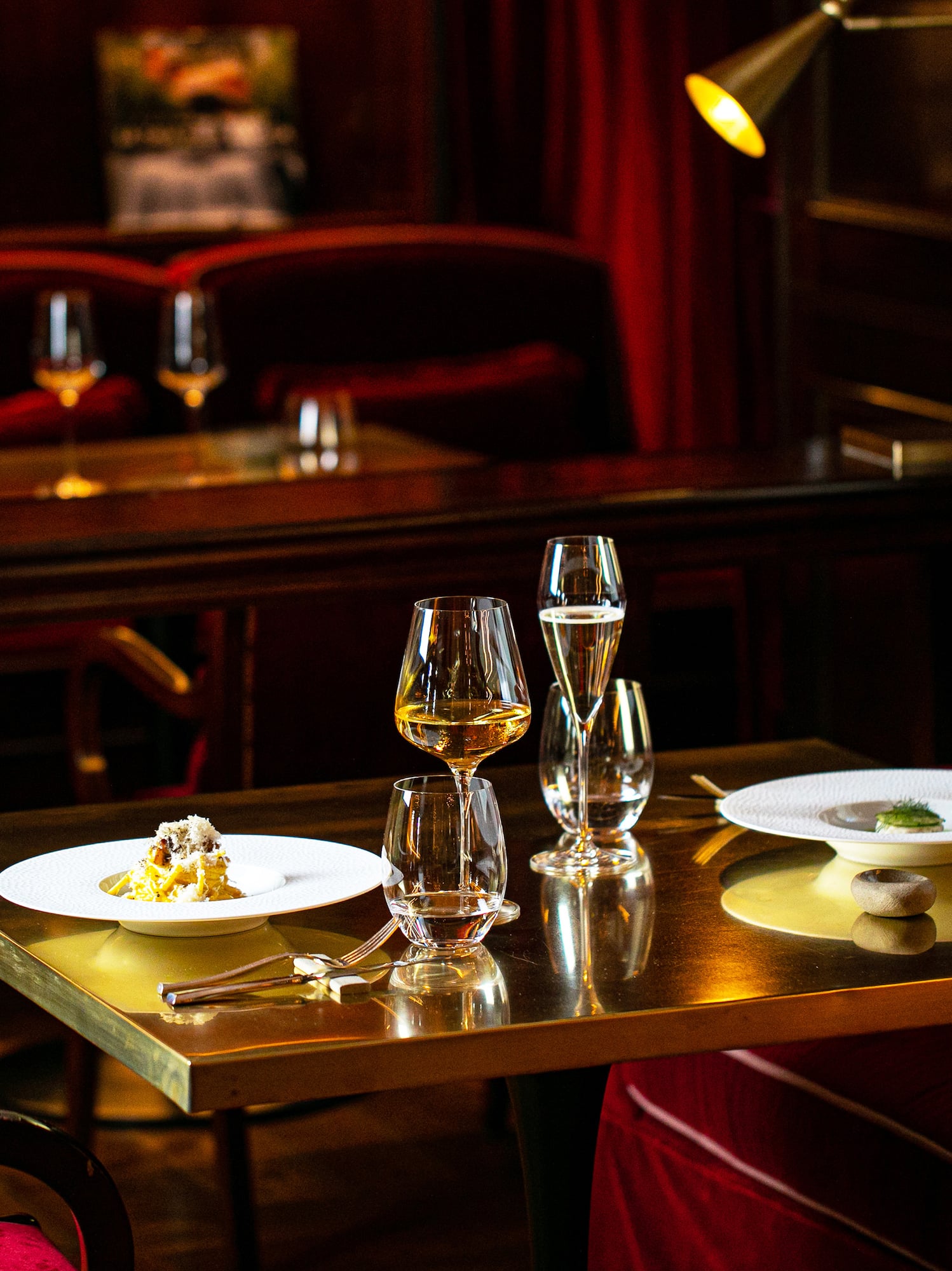 a table with wine glasses and plates on it