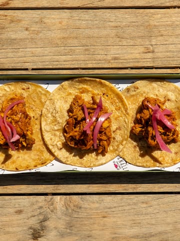 a plate of tacos on a wood table