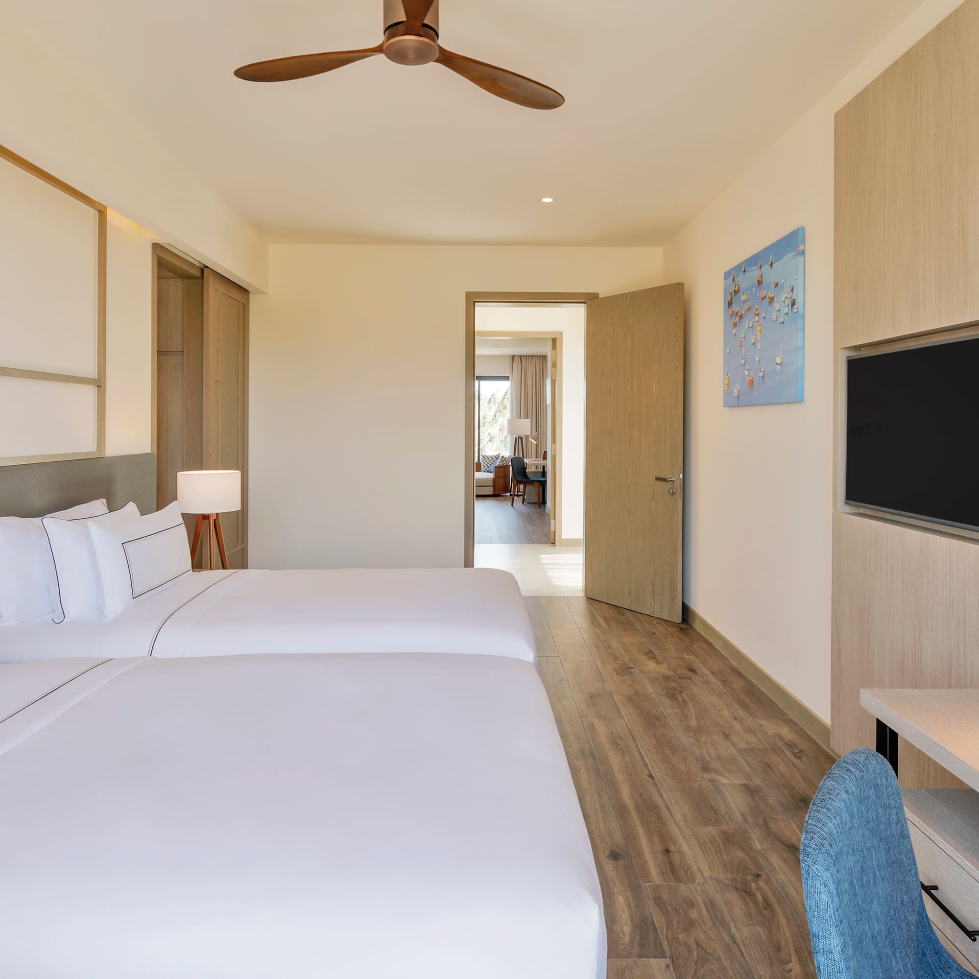 a room with two beds and a tv