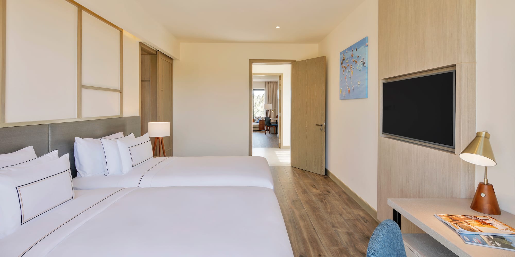 a room with two beds and a tv