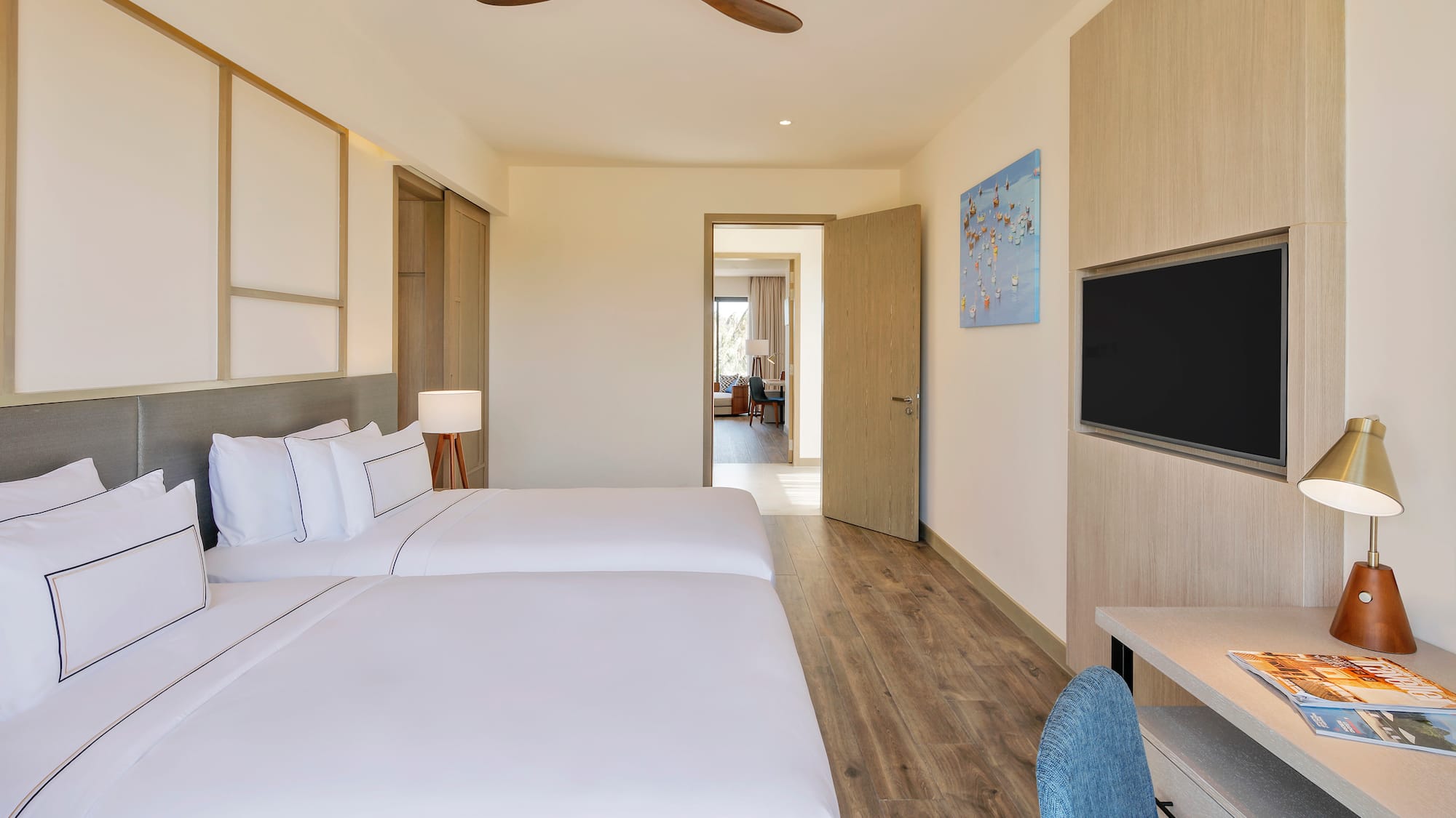 a room with two beds and a tv