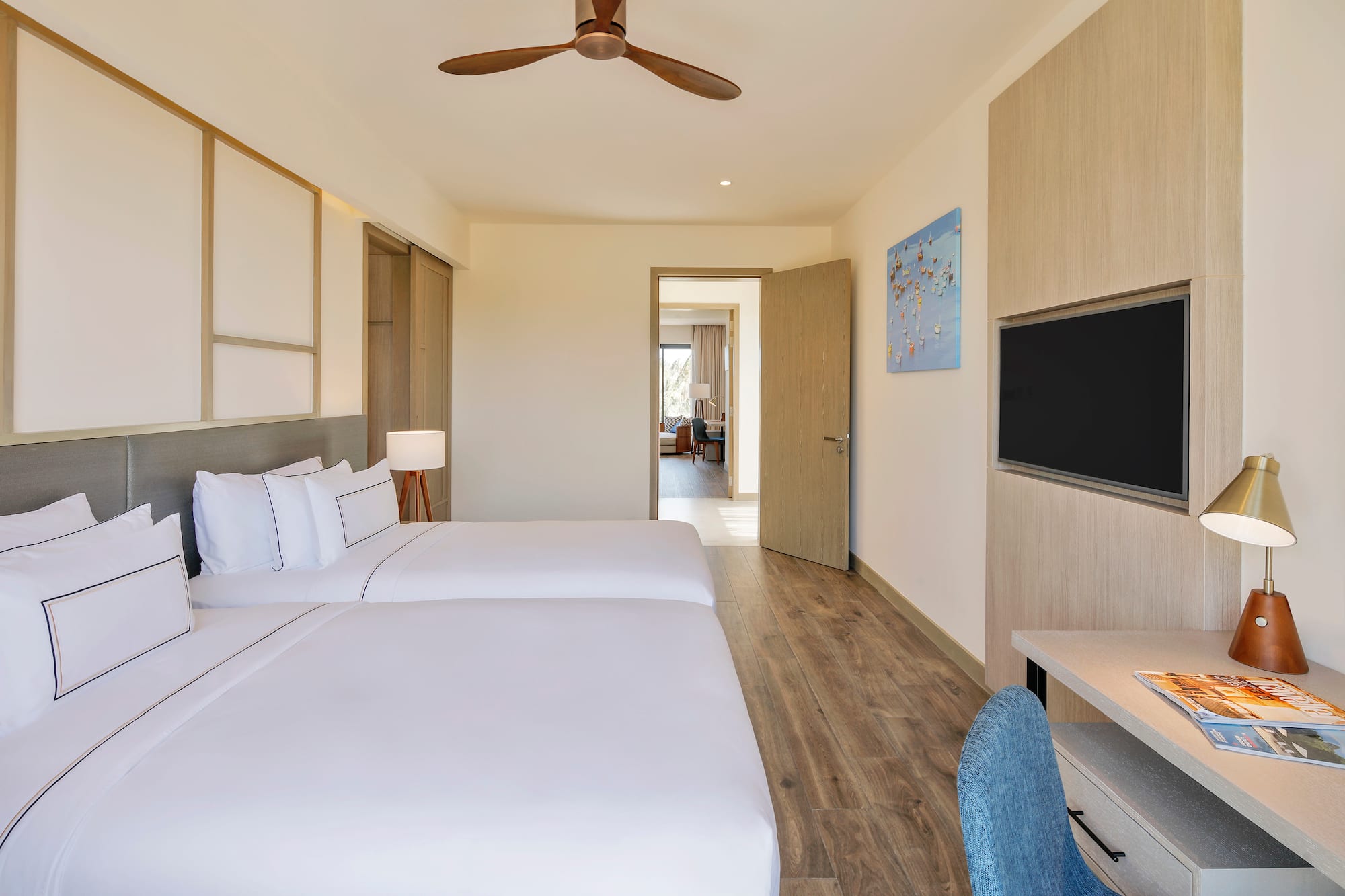 a room with two beds and a tv