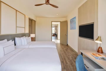 a room with two beds and a tv
