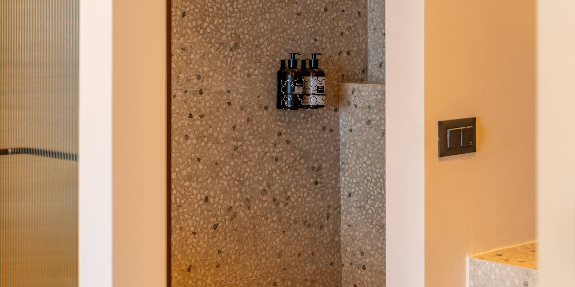 a shower with a shower and a sink