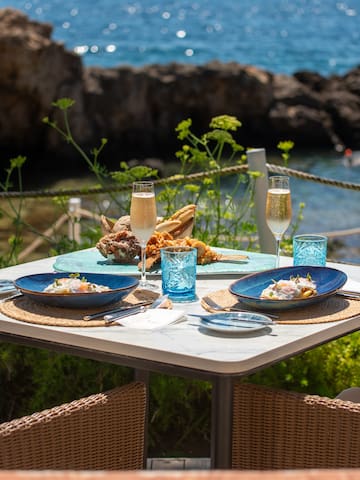 a table with plates of food and glasses on it