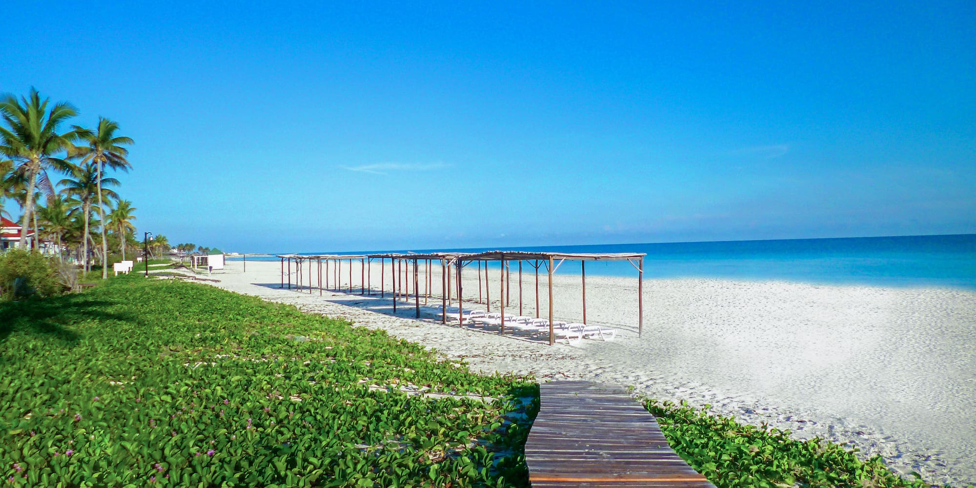 a wooden walkway leading to a beach