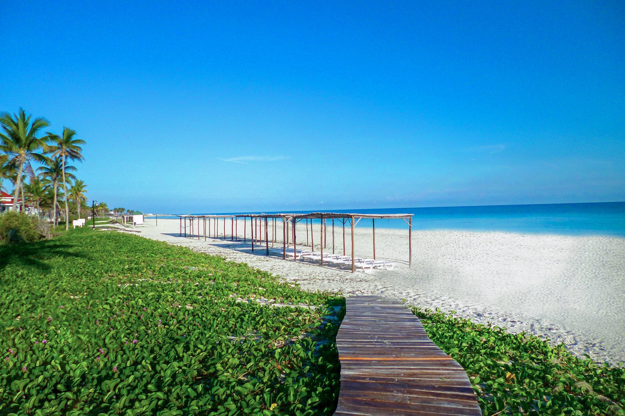 a wooden walkway leading to a beach