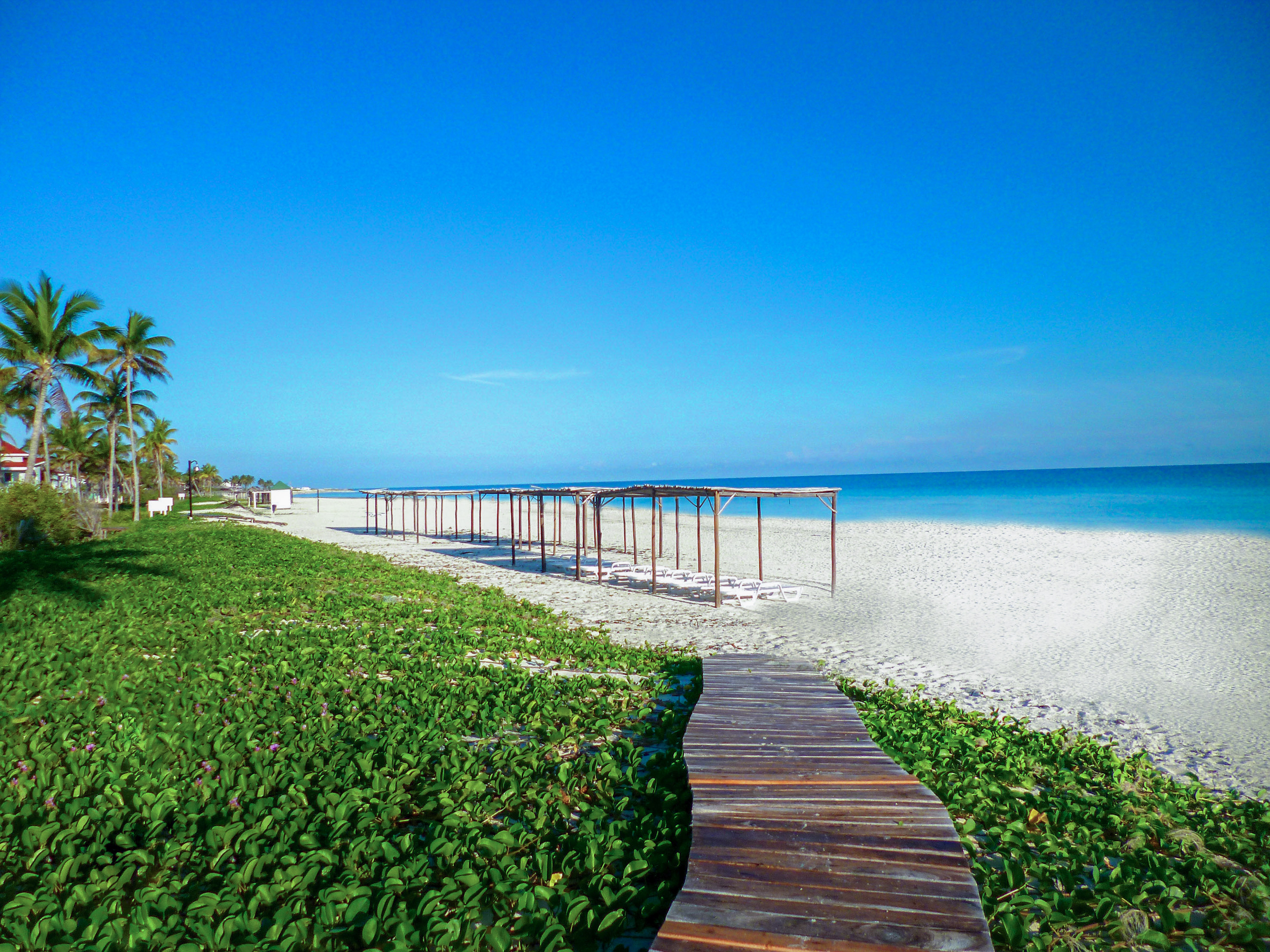 a wooden walkway leading to a beach