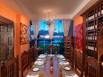 a dining room with a table set with plates and chairs