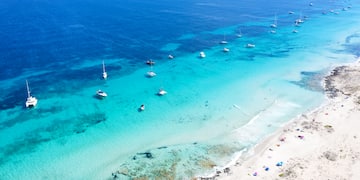 a beach with boats in the water