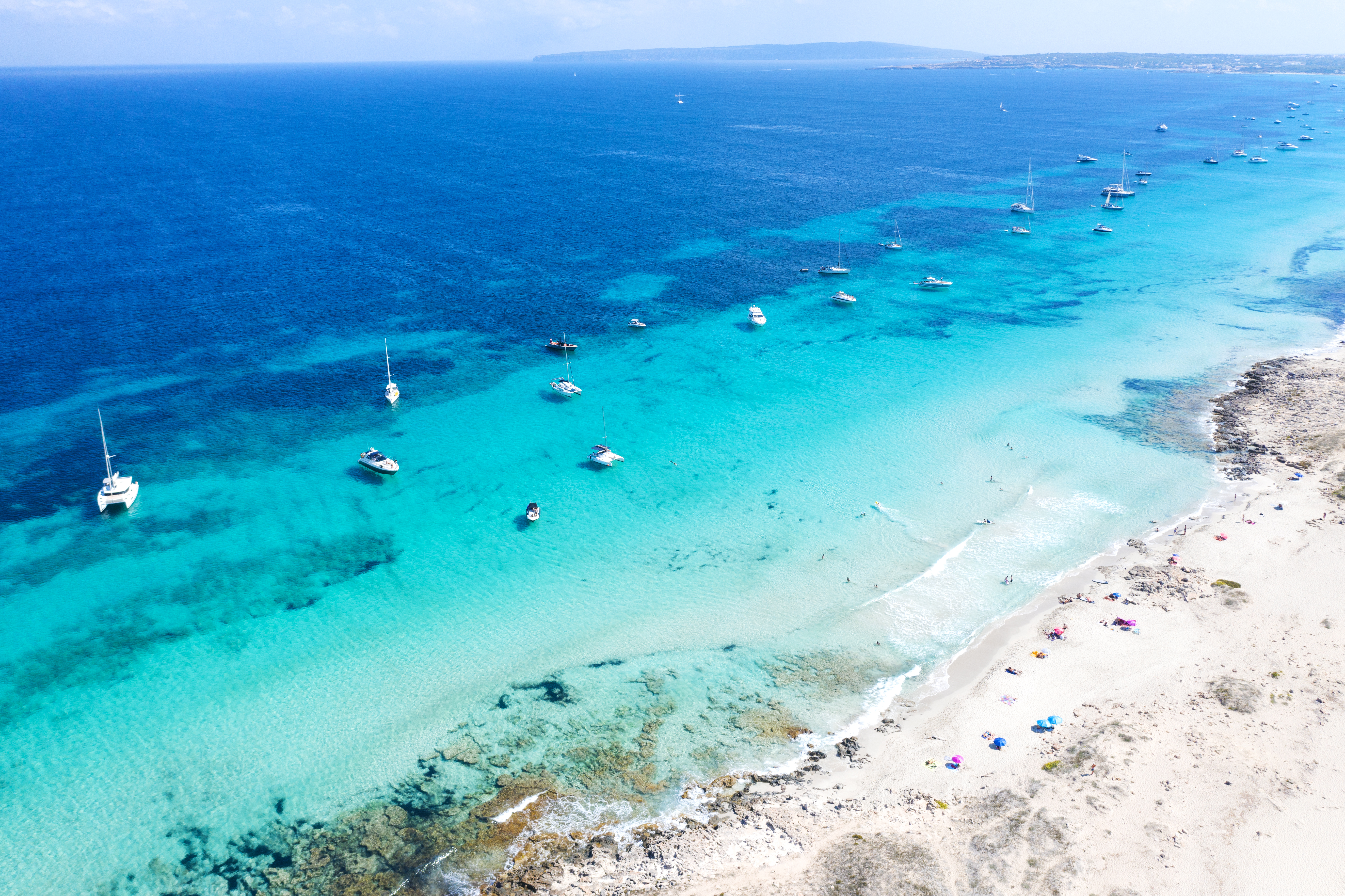 a beach with boats in the water
