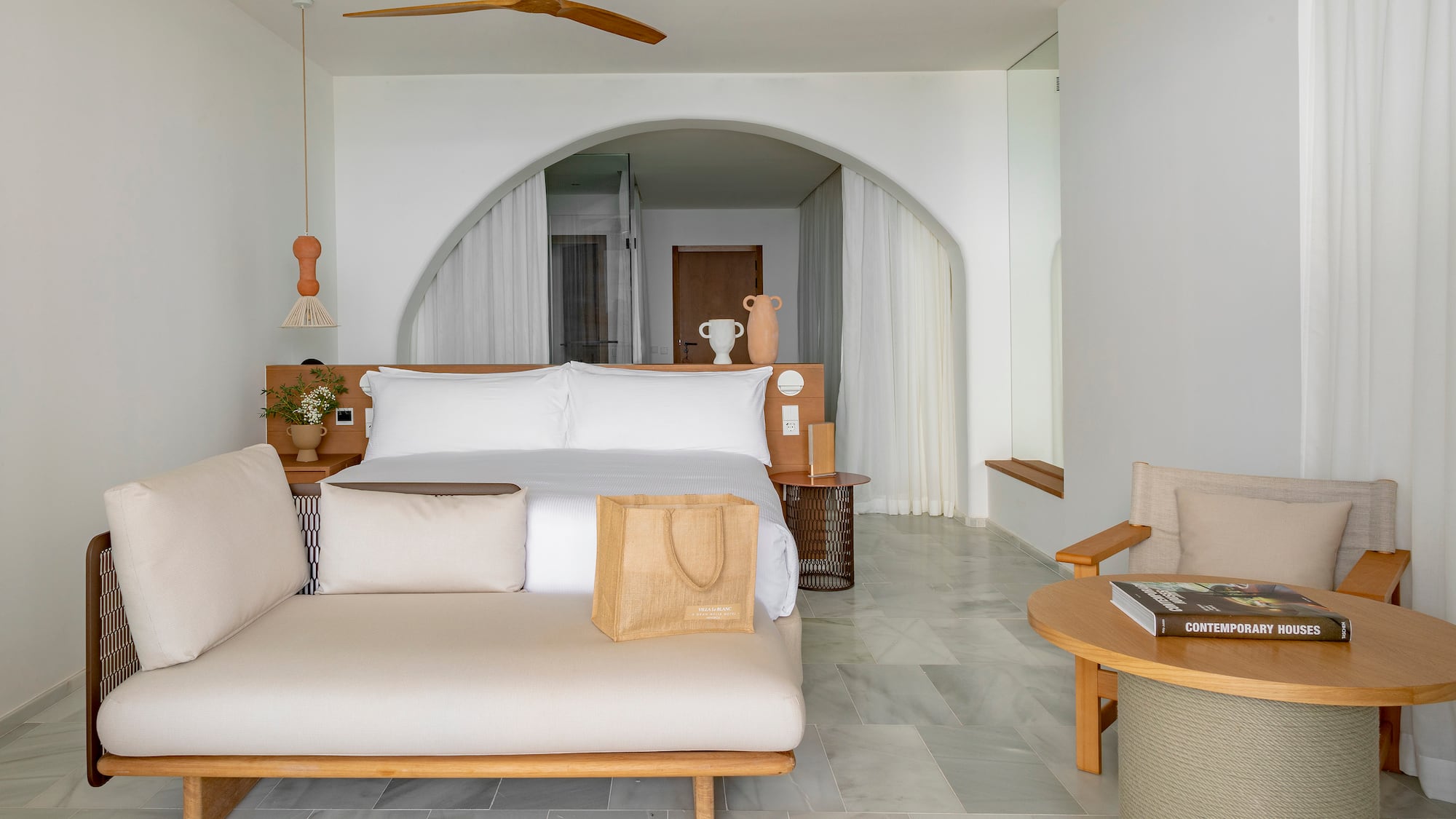 a room with a bed and a fan