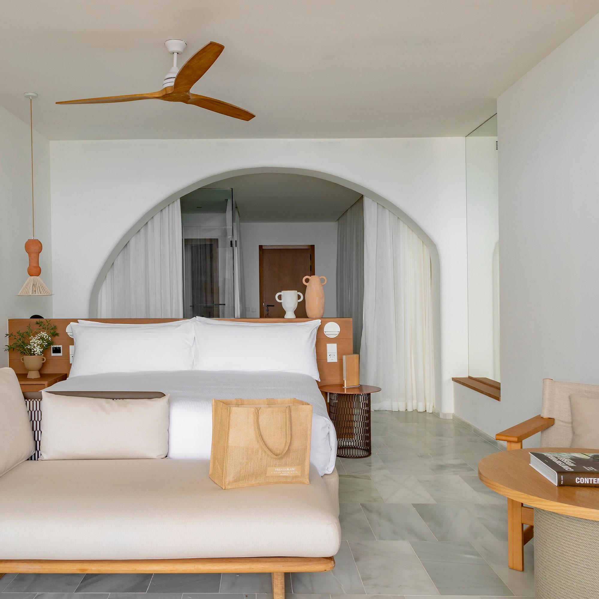 a room with a bed and a fan