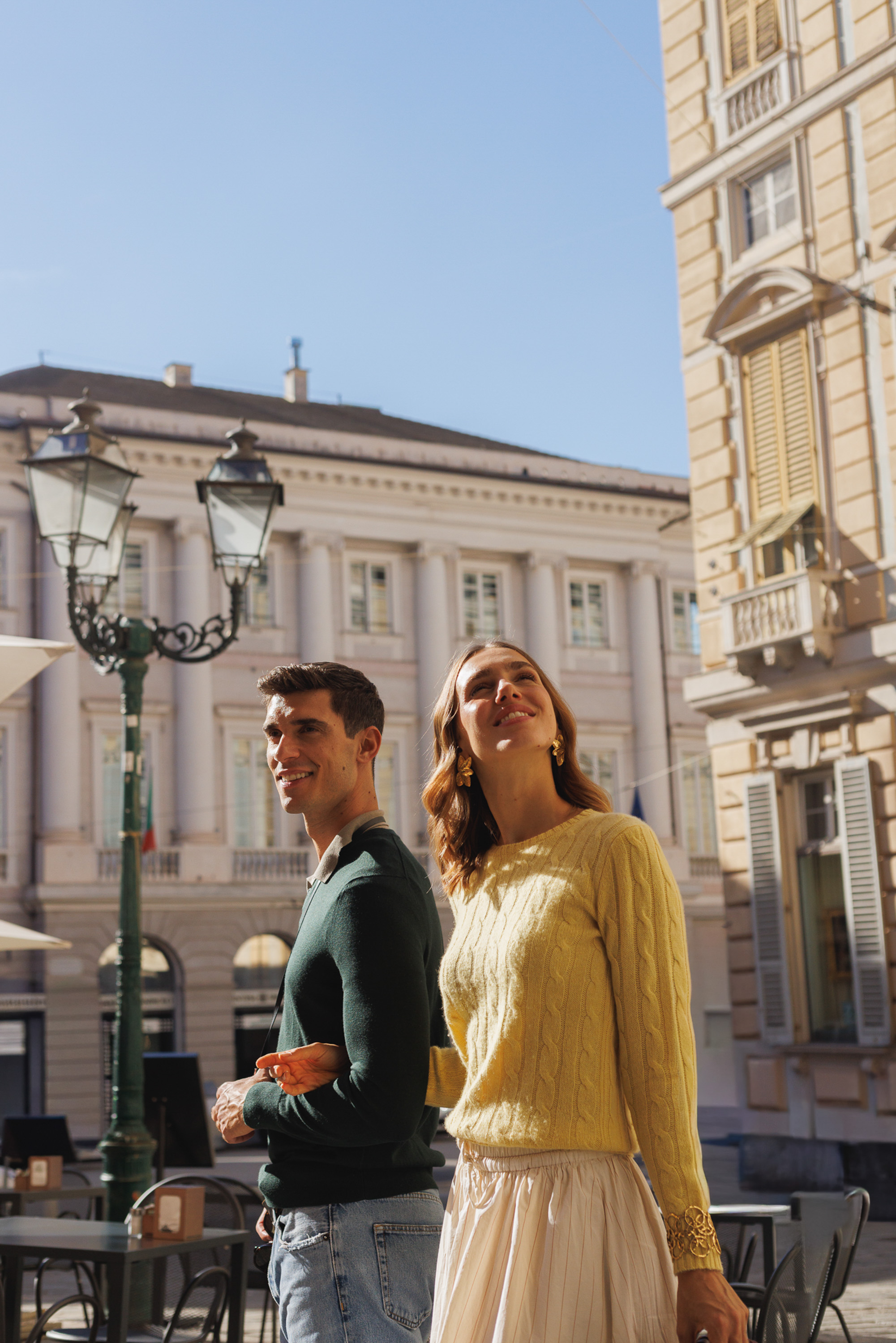 a man and woman standing in a city