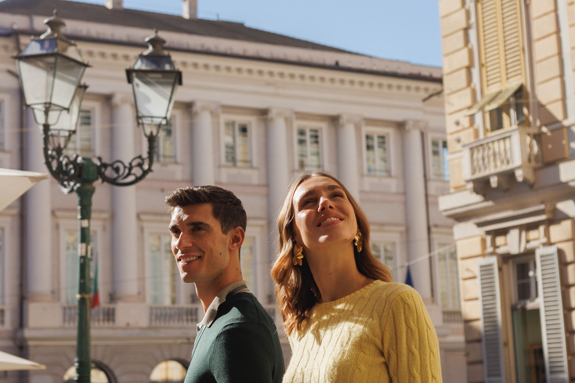 a man and woman standing in a city