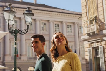a man and woman standing in a city