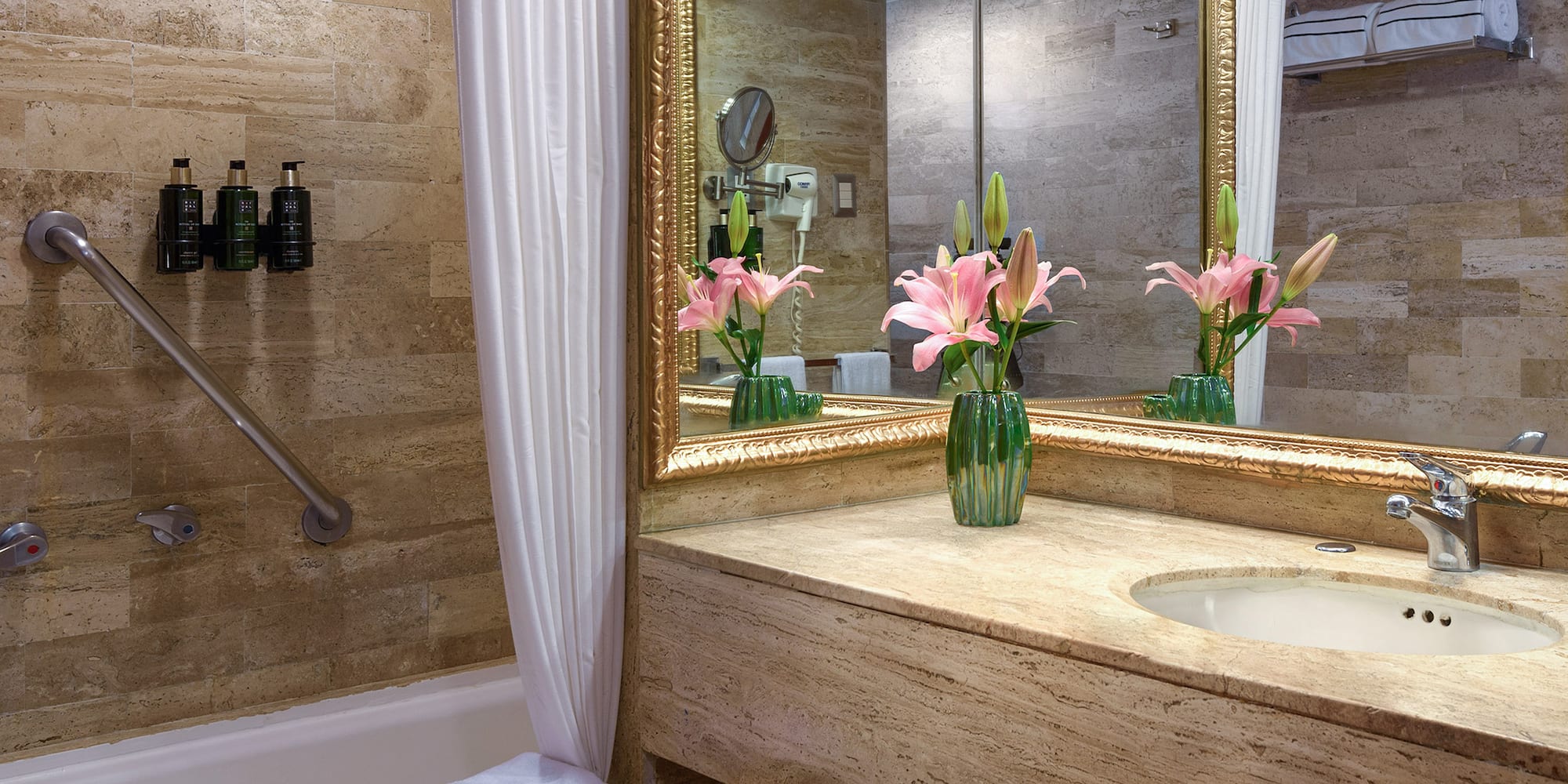 a bathroom with a marble countertop and a sink and a mirror