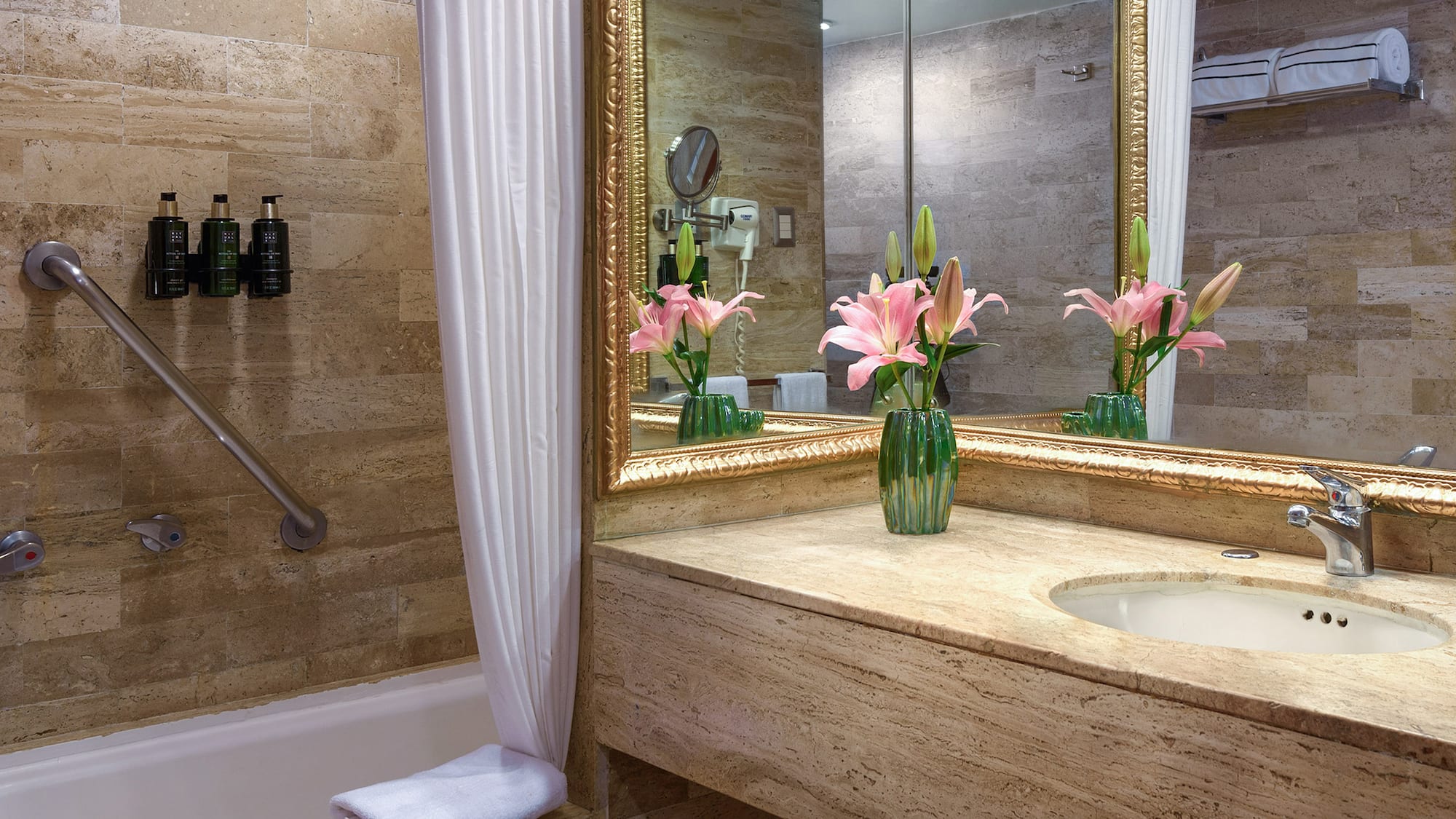 a bathroom with a marble countertop and a sink and a mirror