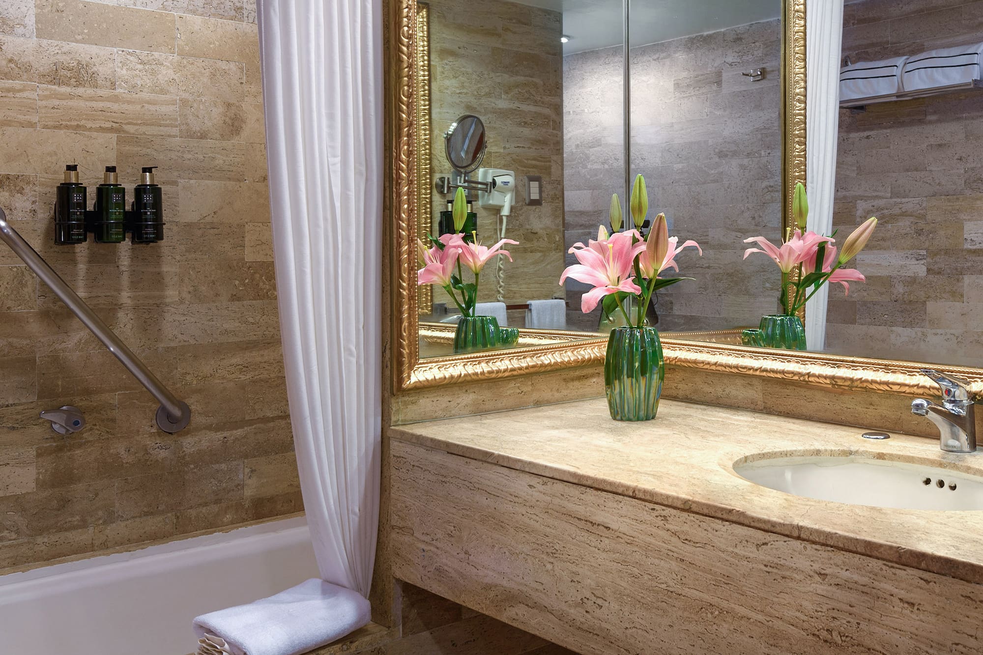 a bathroom with a marble countertop and a sink and a mirror
