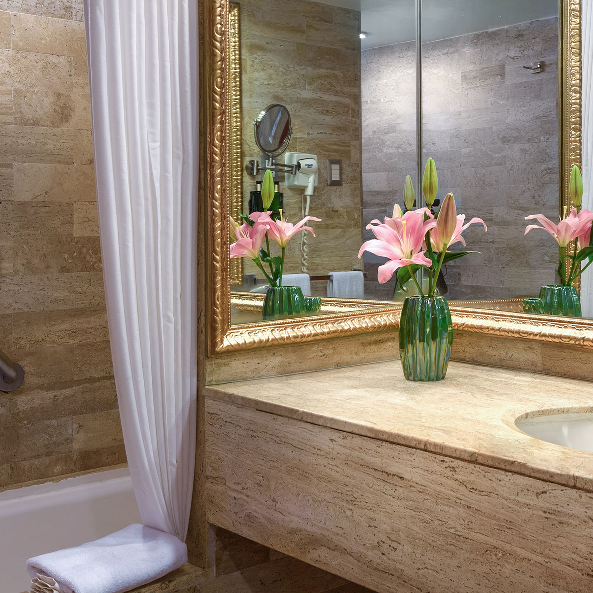 a bathroom with a marble countertop and a sink and a mirror