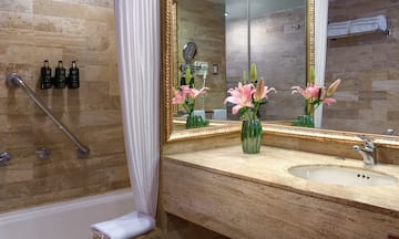 a bathroom with a marble countertop and a sink and a mirror