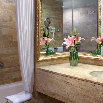 a bathroom with a marble countertop and a sink and a mirror