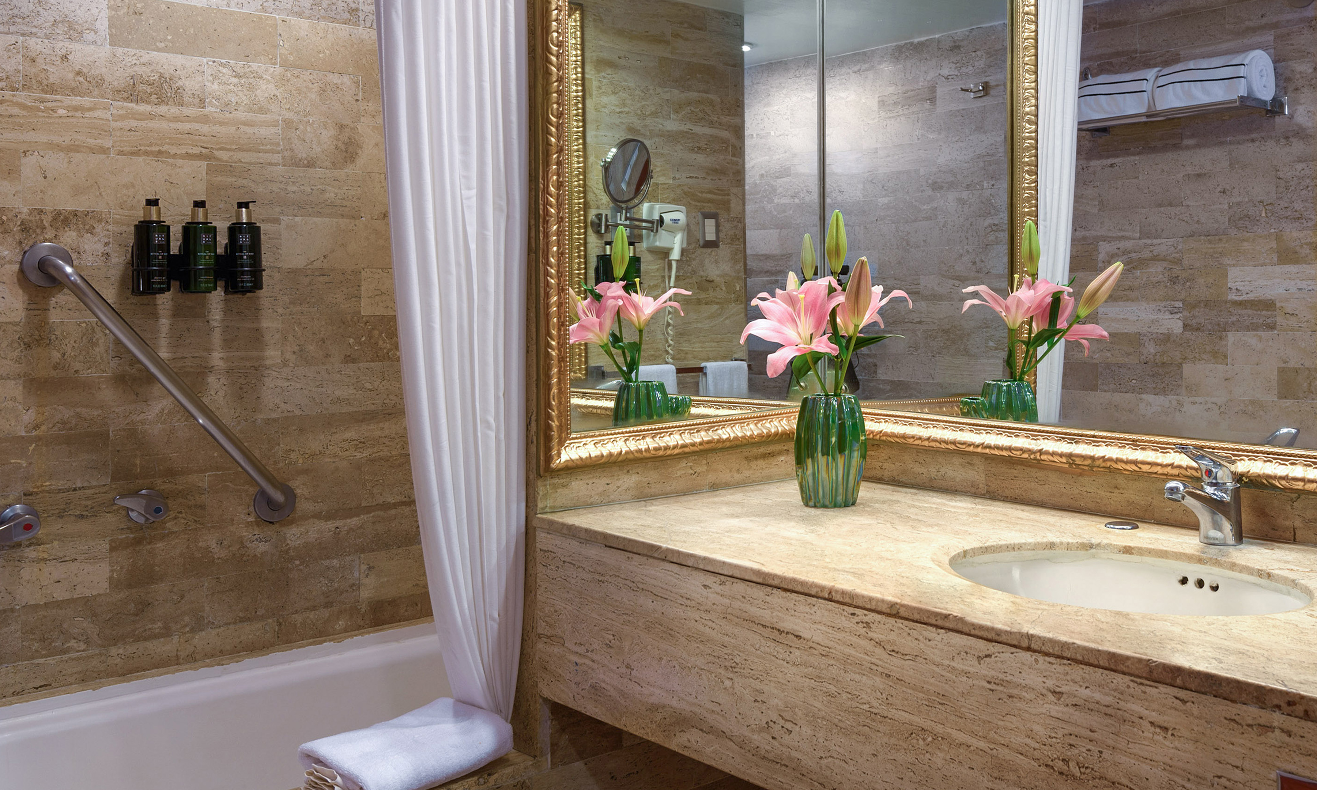 a bathroom with a marble countertop and a sink and a mirror