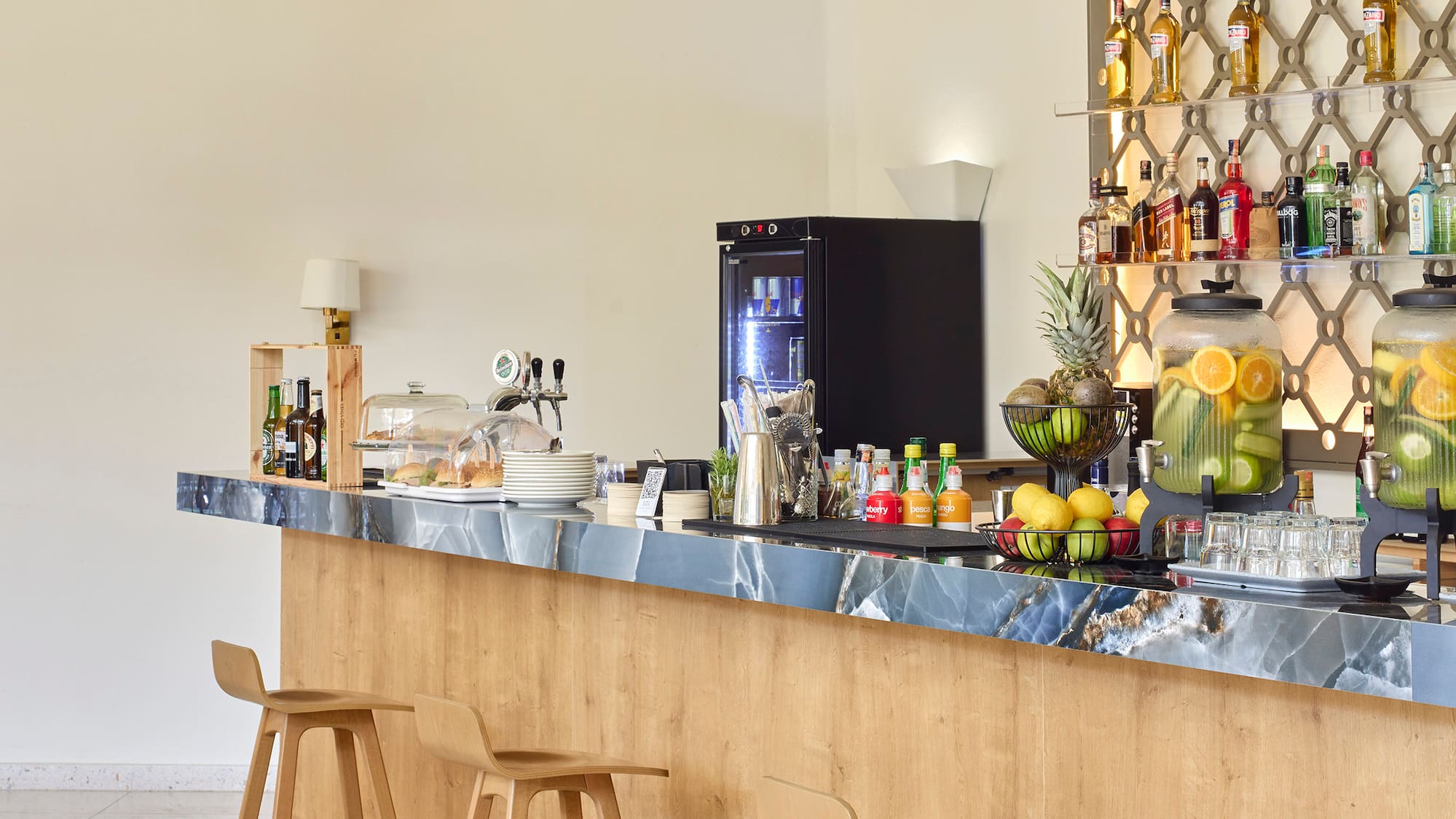 a bar with bottles of liquid on the wall