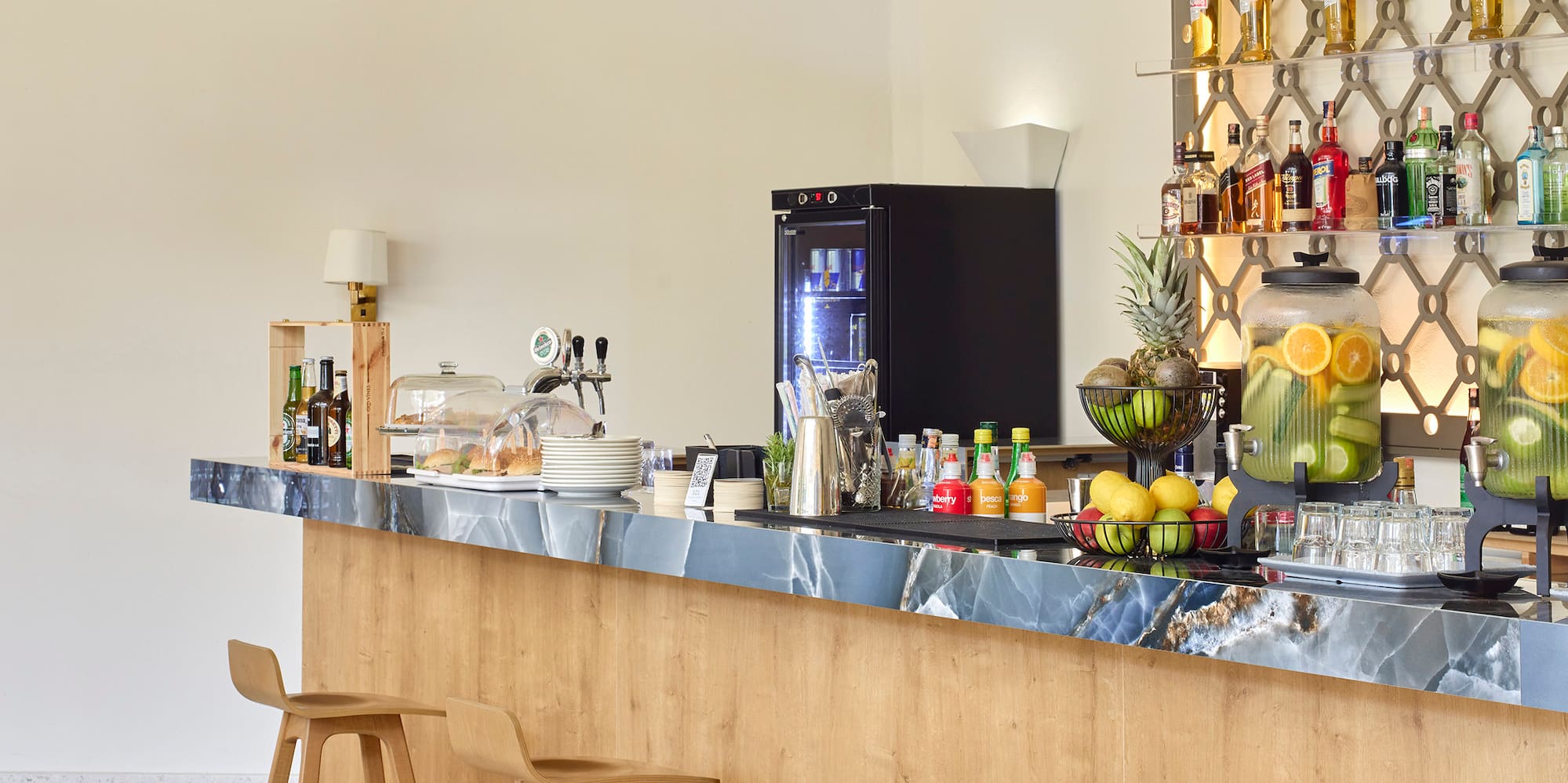a bar with bottles of liquid on the wall