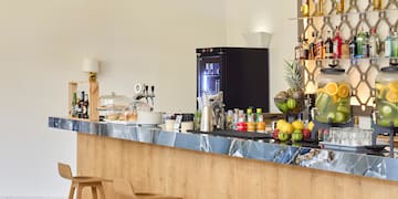 a bar with bottles of liquid on the wall