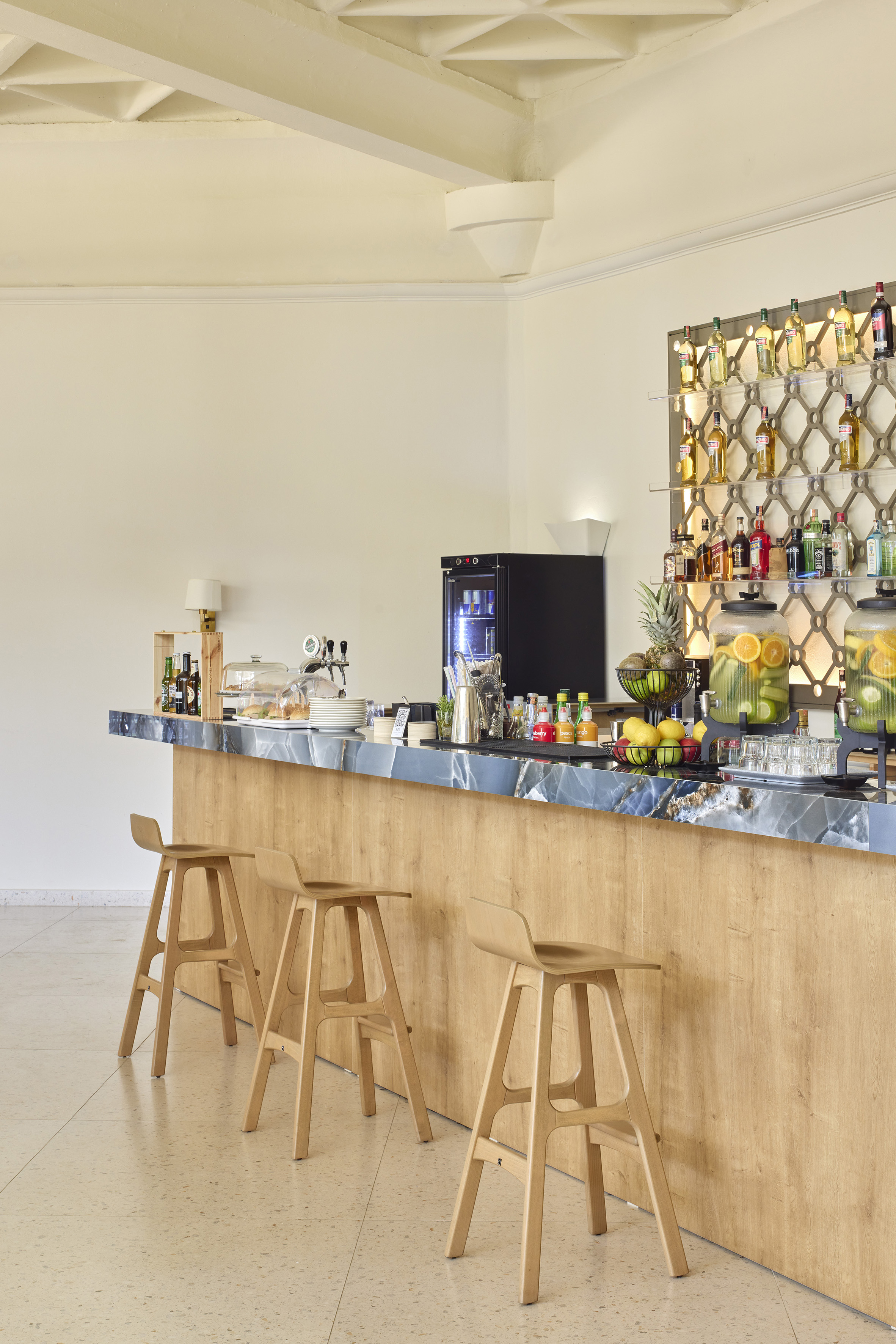 a bar with bottles of liquid on the wall