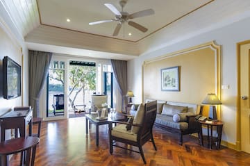 a living room with a ceiling fan and couches