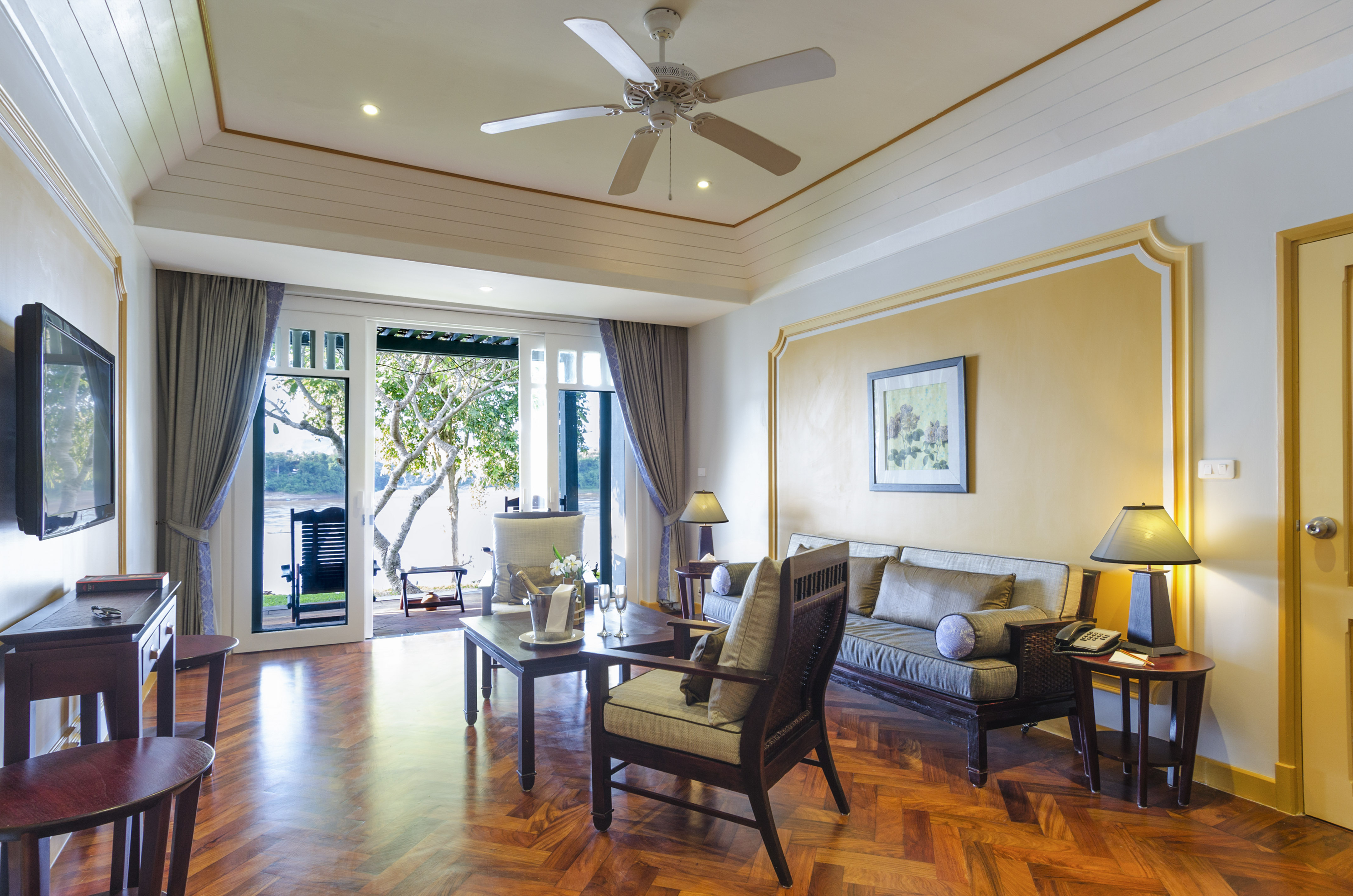 Luxury living room suite with river view balcony and hardwood floor.