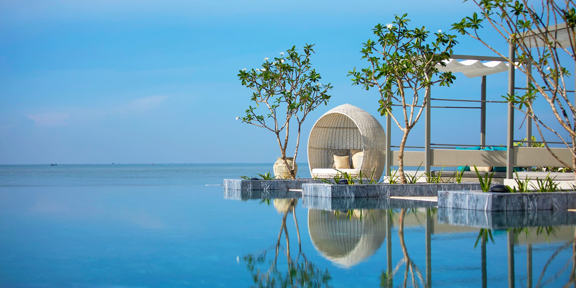 a pool with a chair and trees