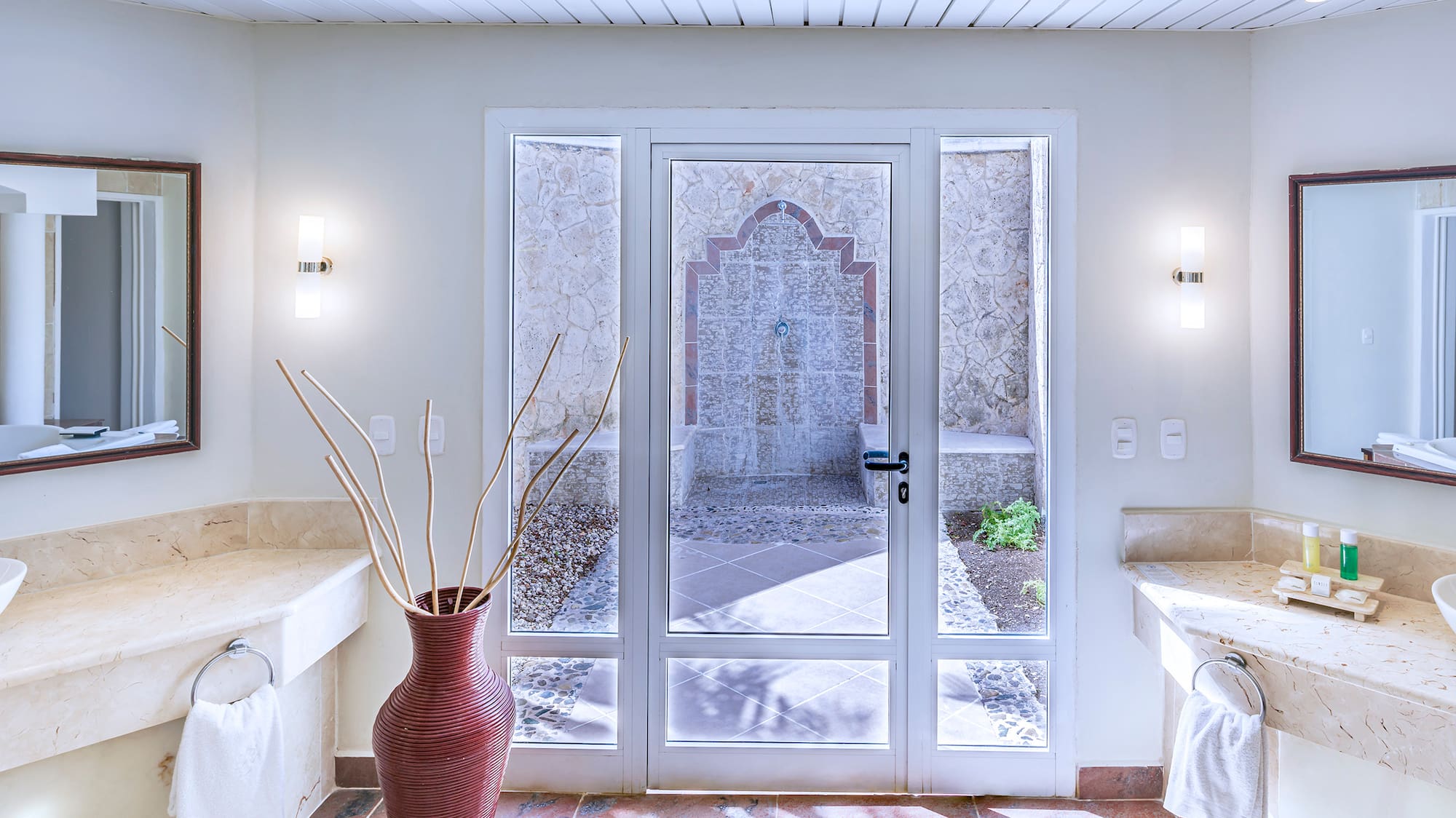 a bathroom with marble countertops and double sinks