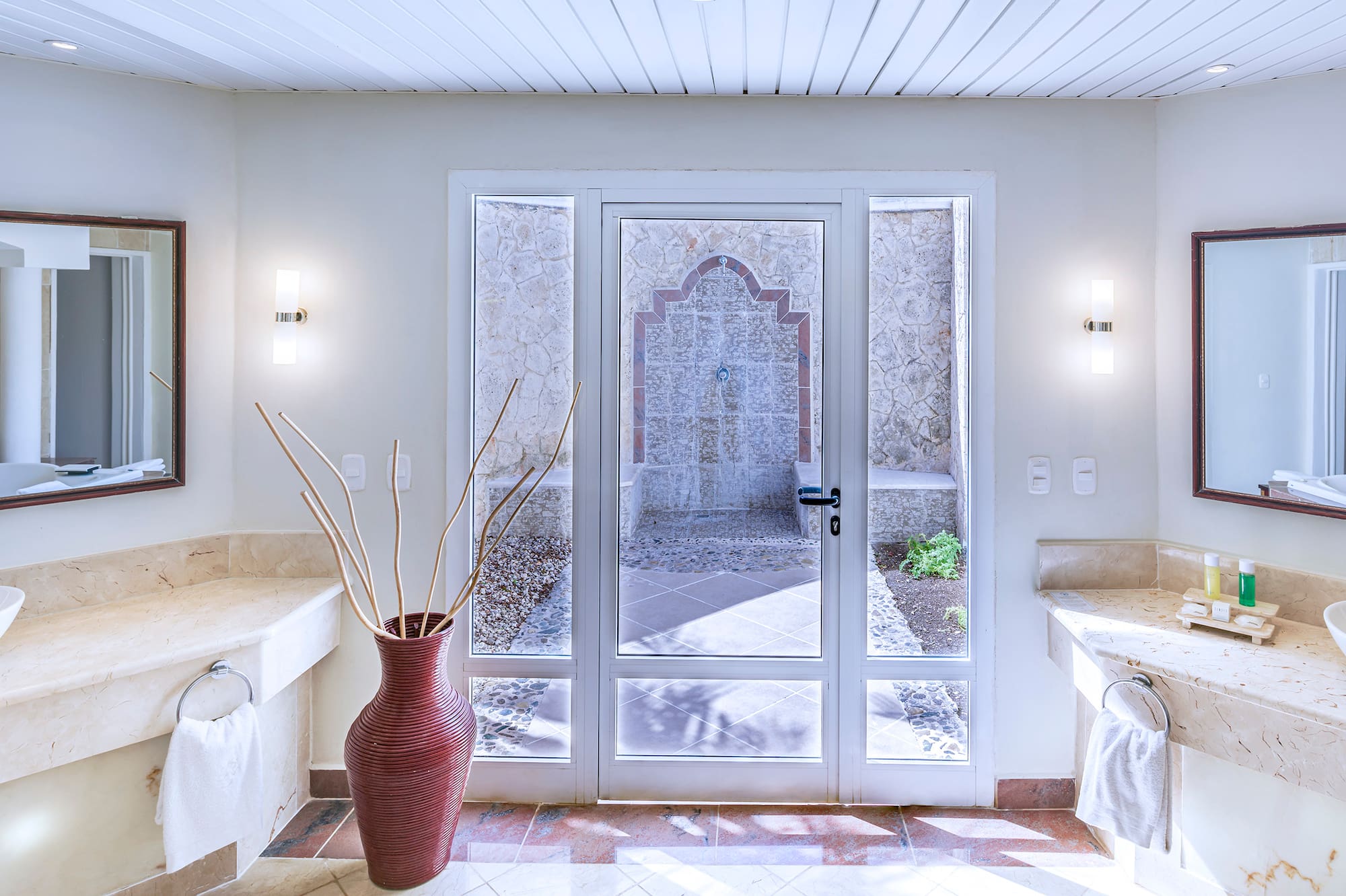 a bathroom with marble countertops and double sinks