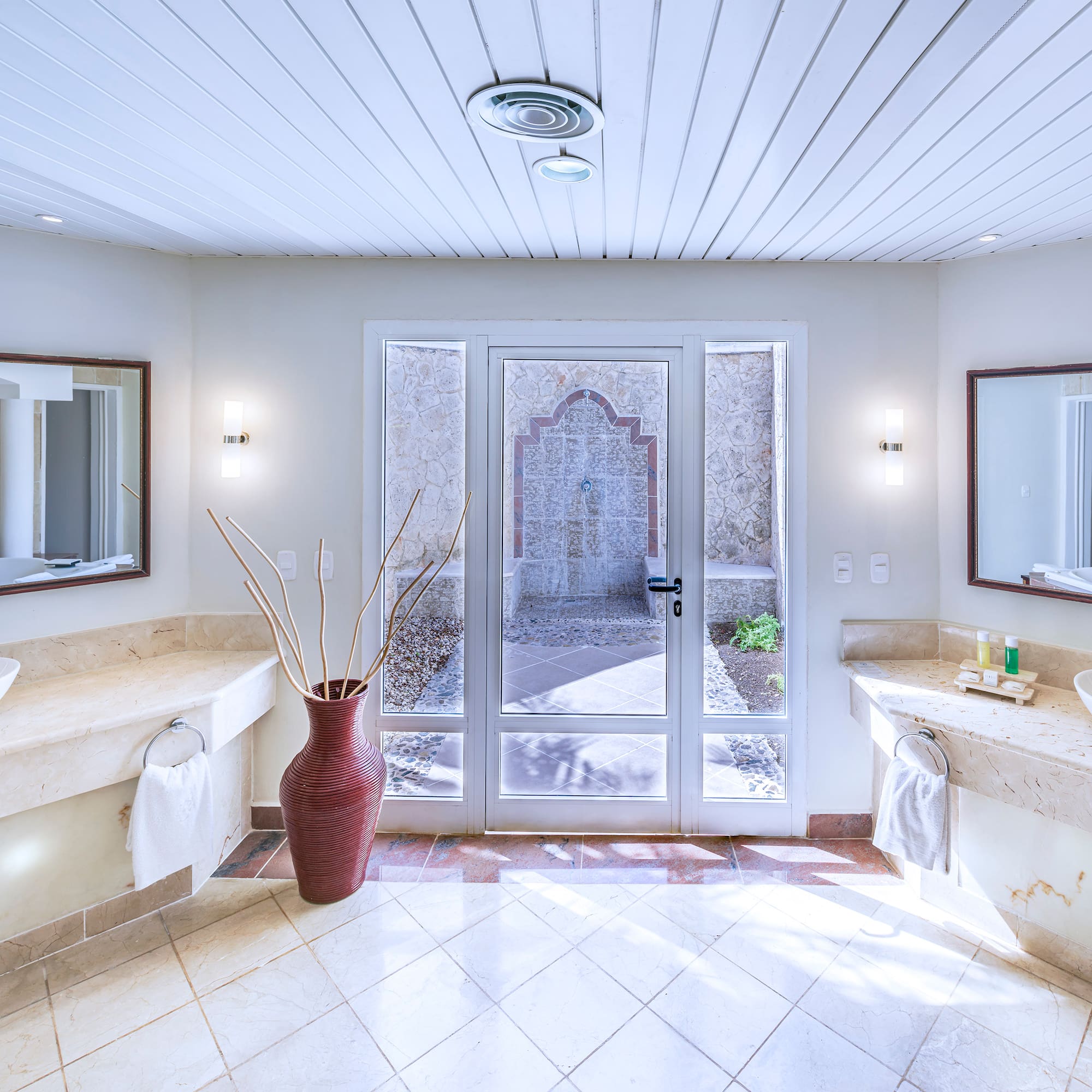 a bathroom with marble countertops and double sinks