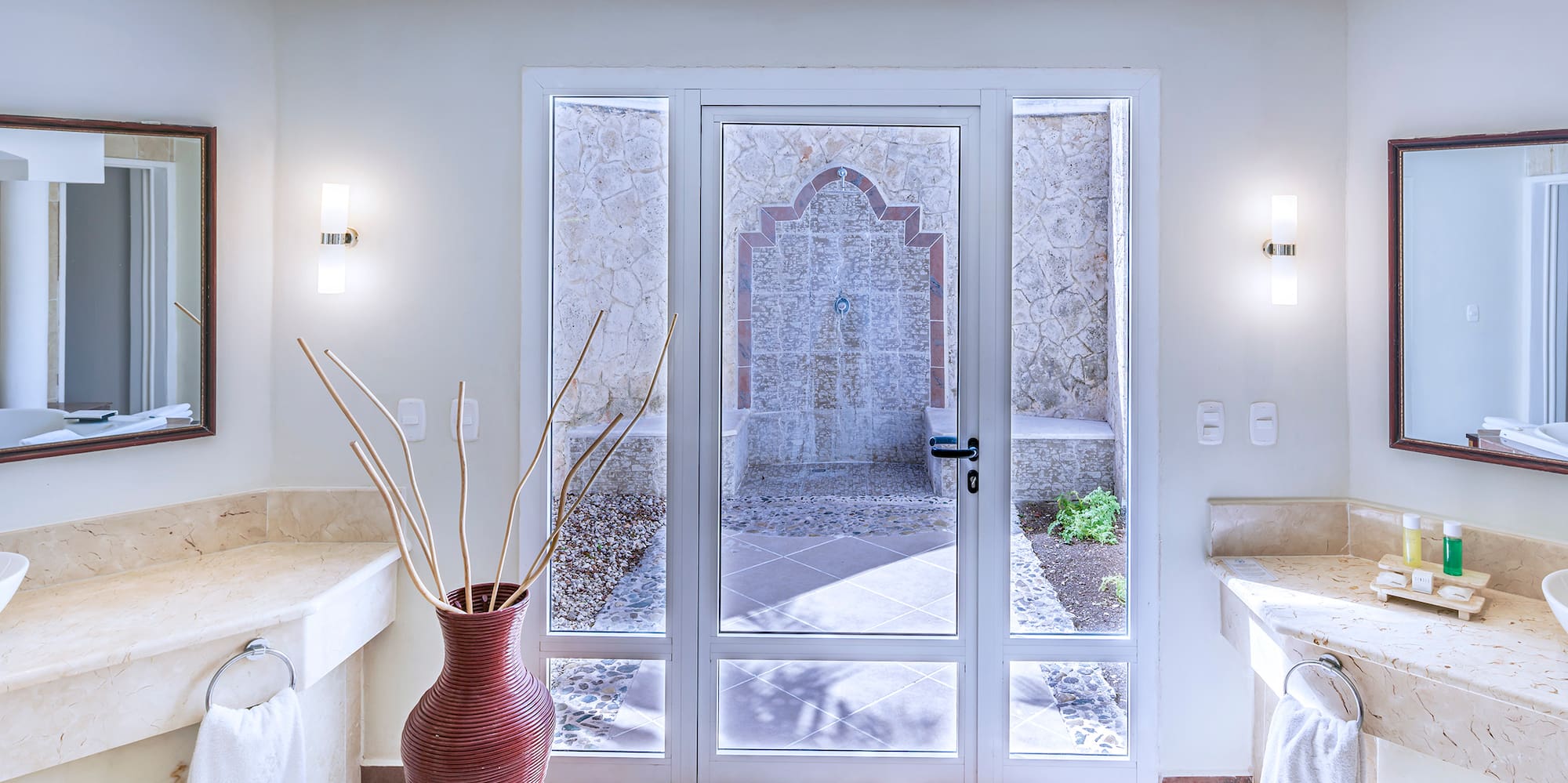 a bathroom with marble countertops and double sinks