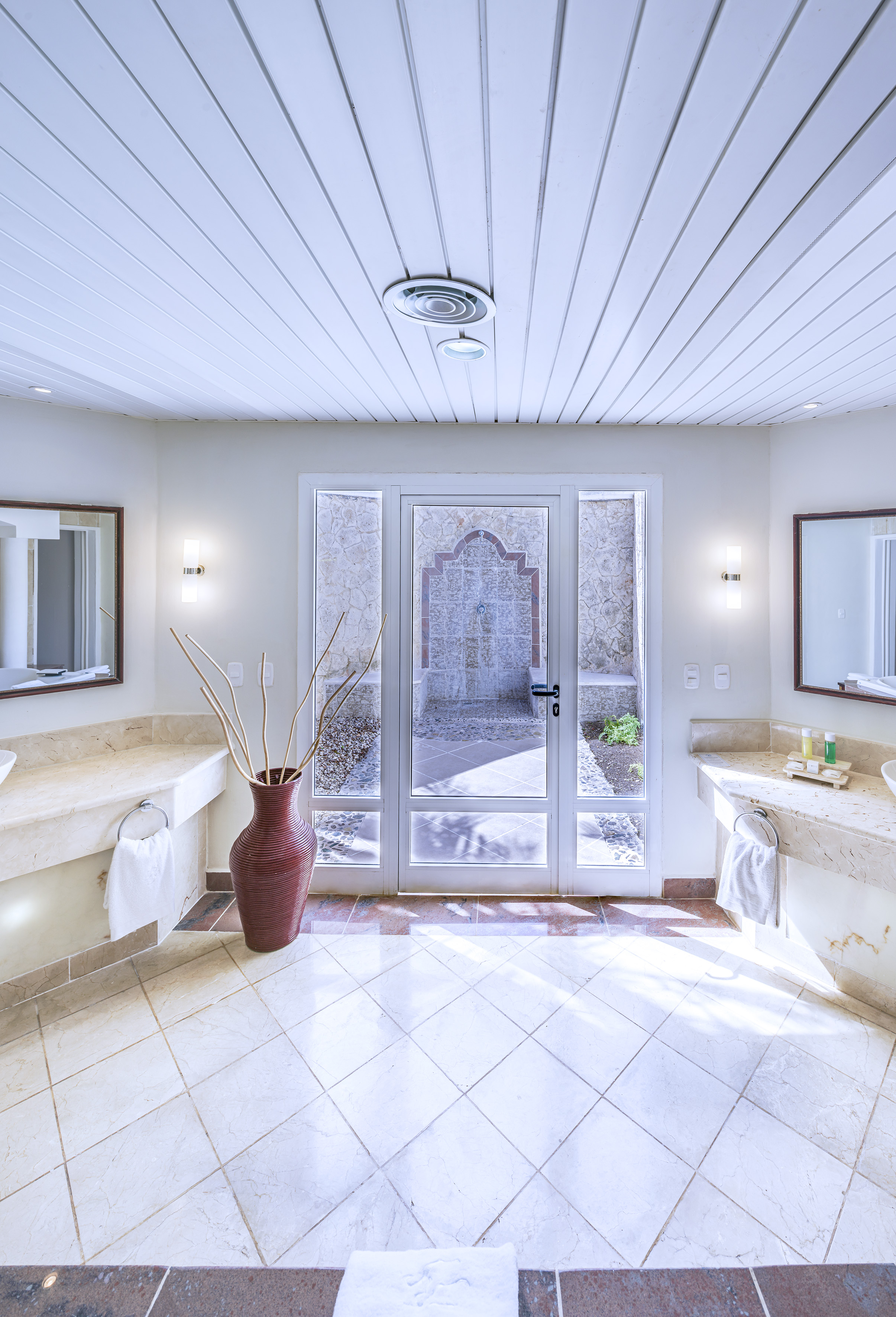 a bathroom with marble countertops and double sinks
