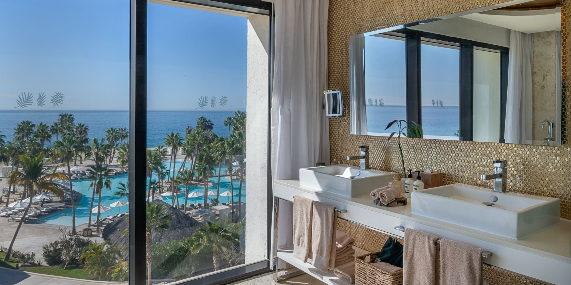 a bathroom with a large window overlooking the ocean