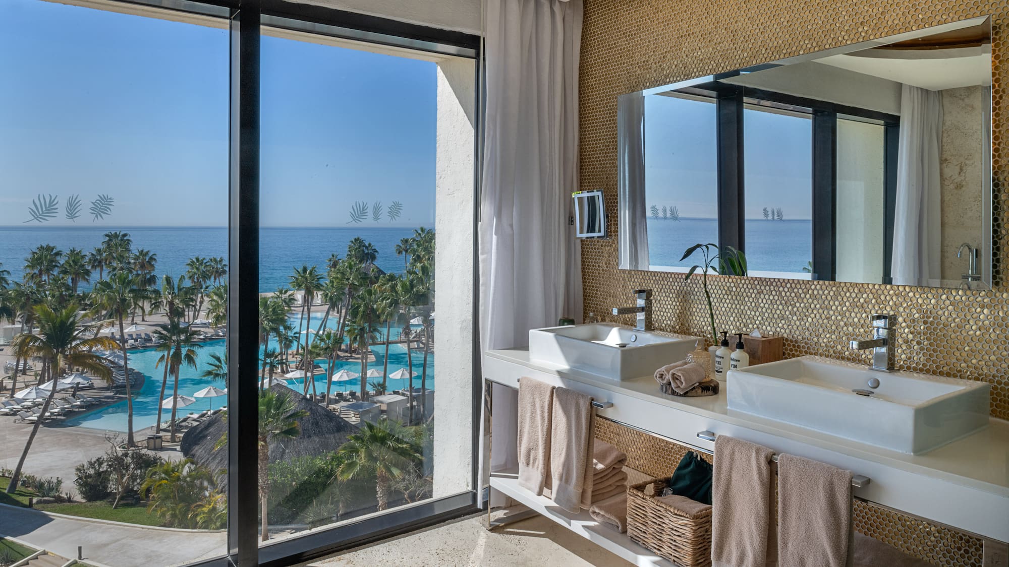 a bathroom with a large window overlooking the ocean