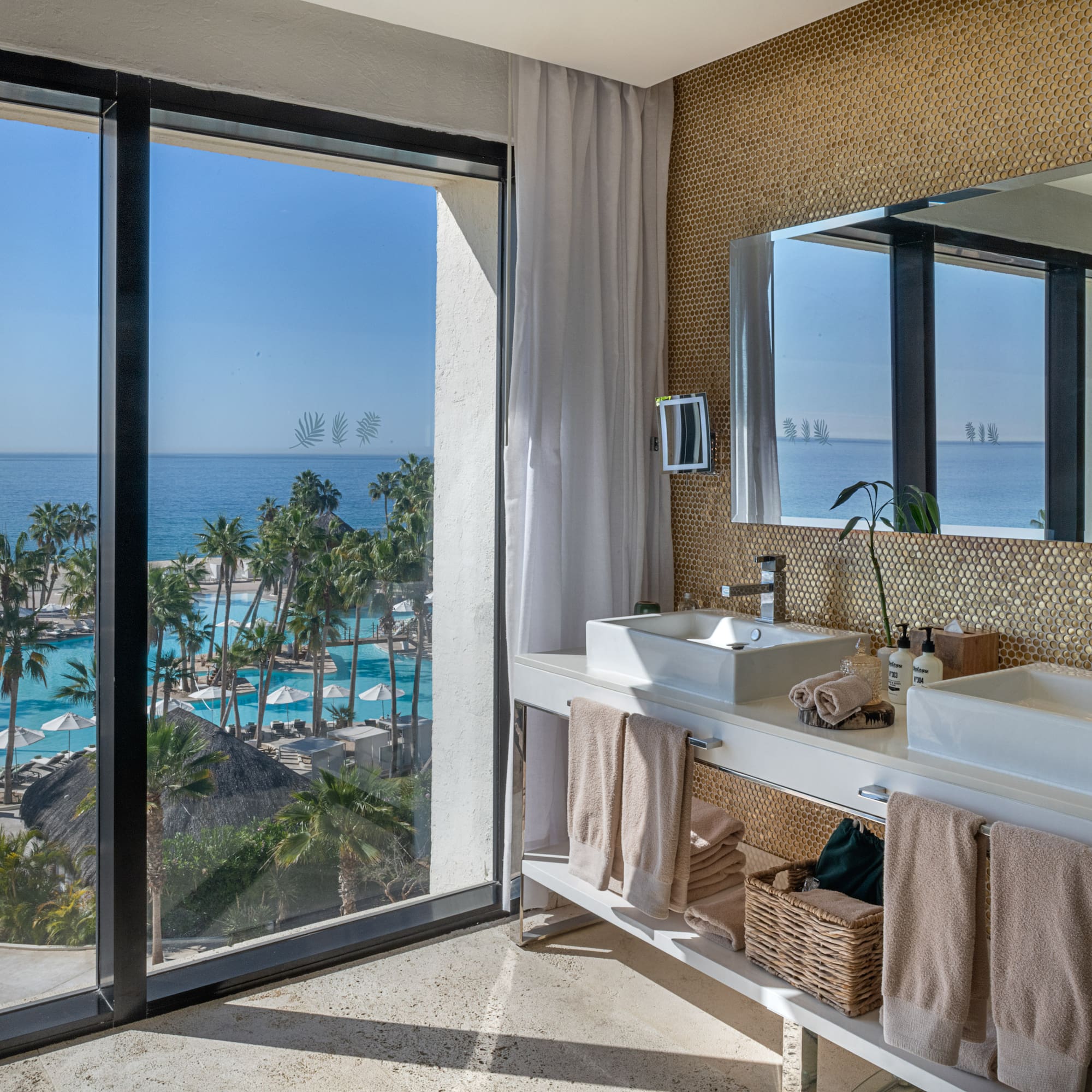 a bathroom with a large window overlooking the ocean