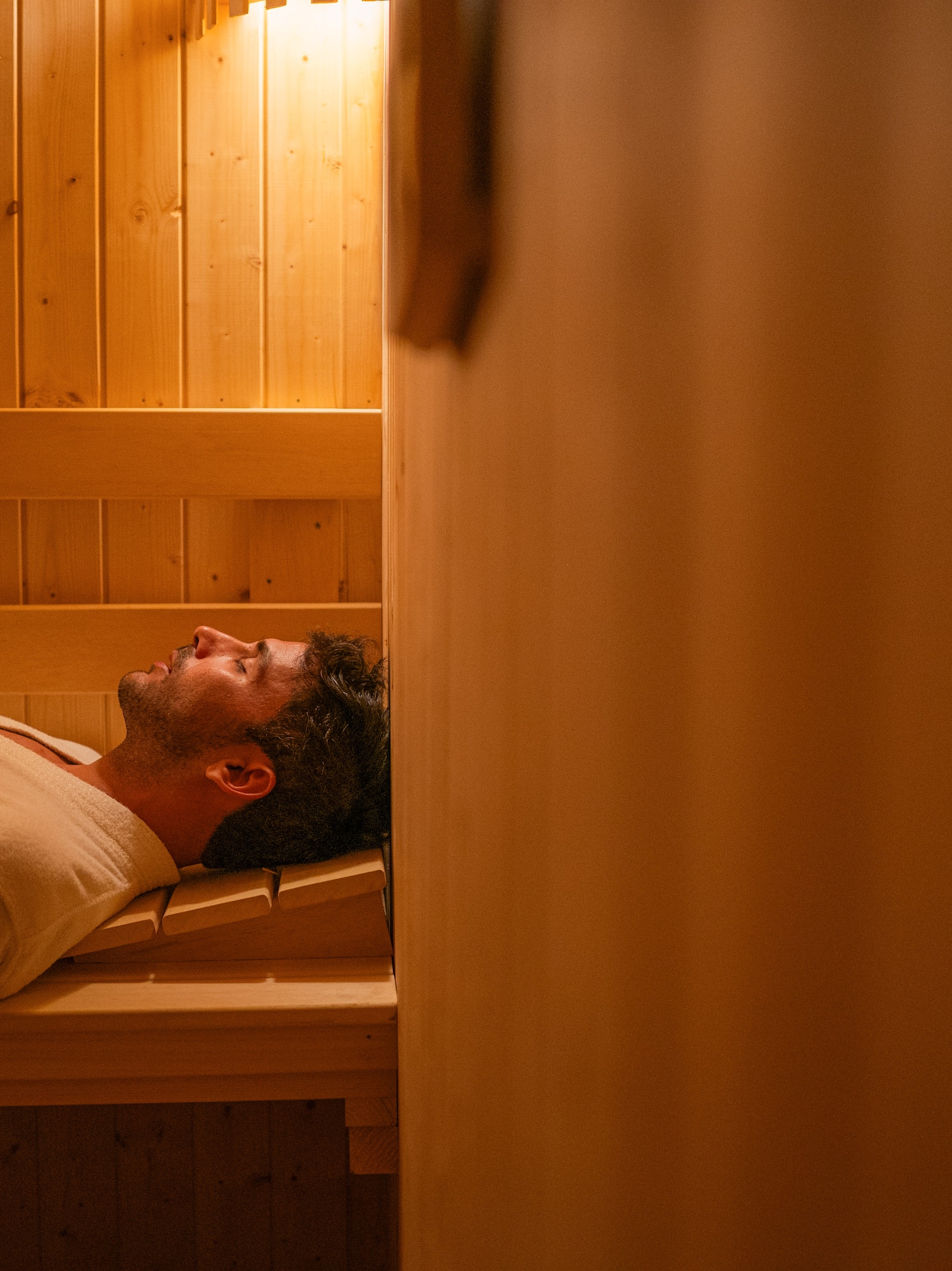 a man lying in a sauna