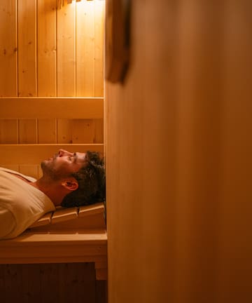 a man lying in a sauna