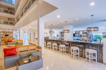 a bar with a counter and chairs