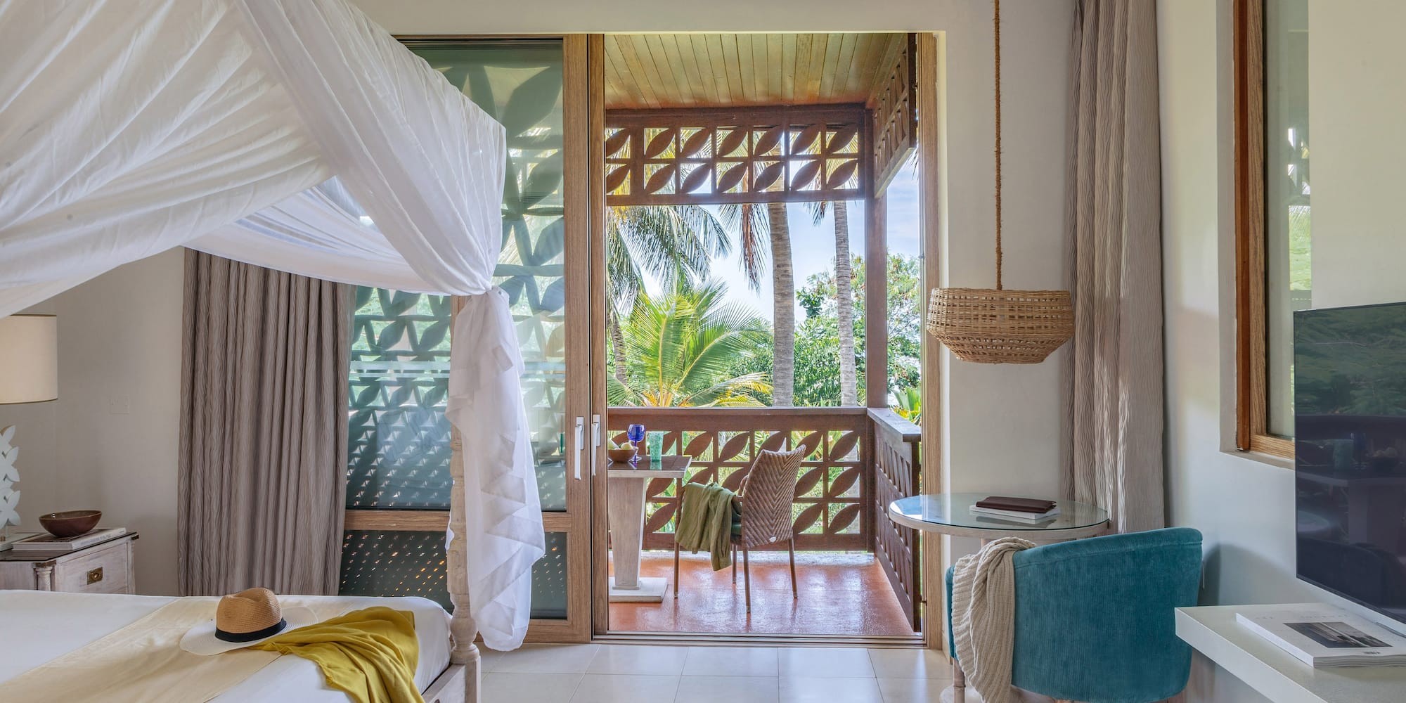 a room with a bed and a table and chairs