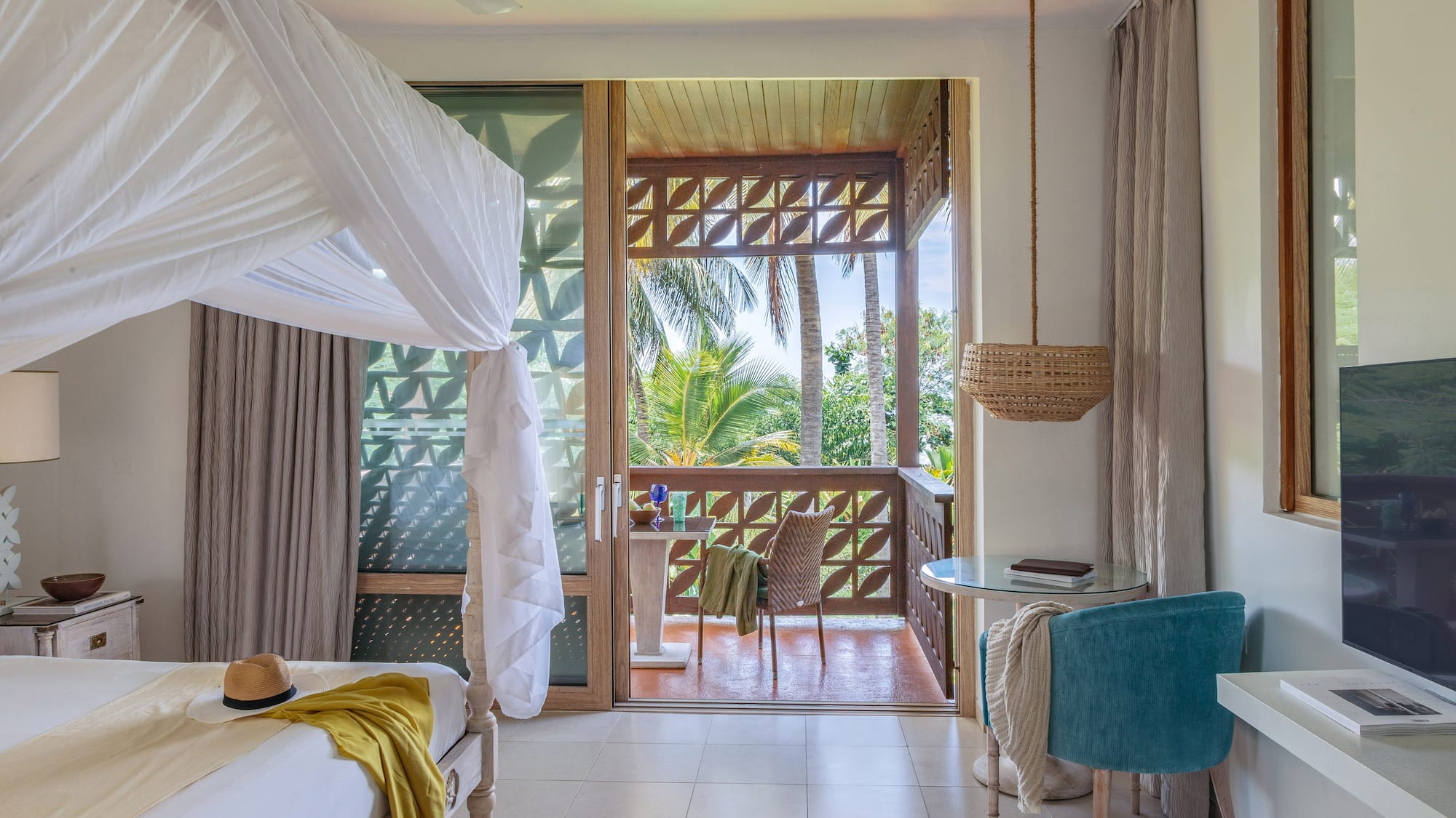 a room with a bed and a table and chairs