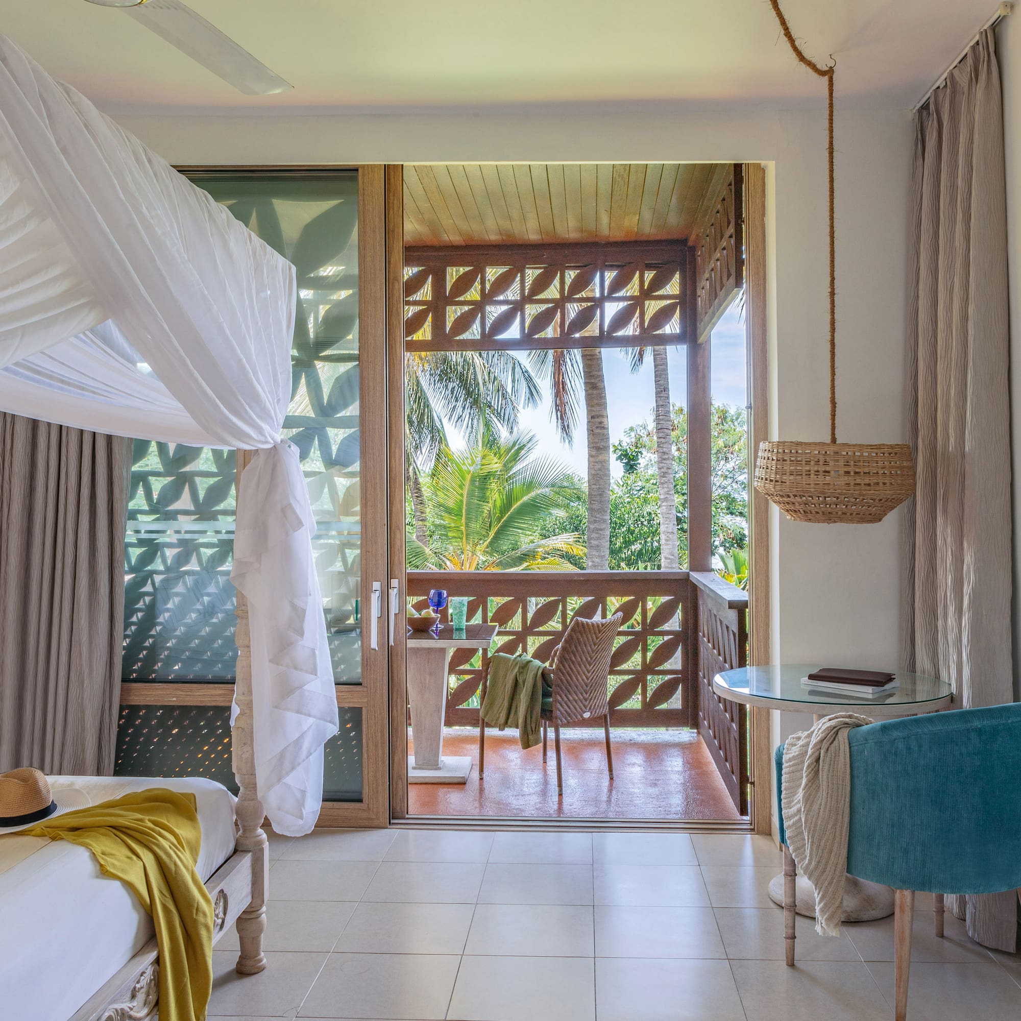 a room with a bed and a table and chairs