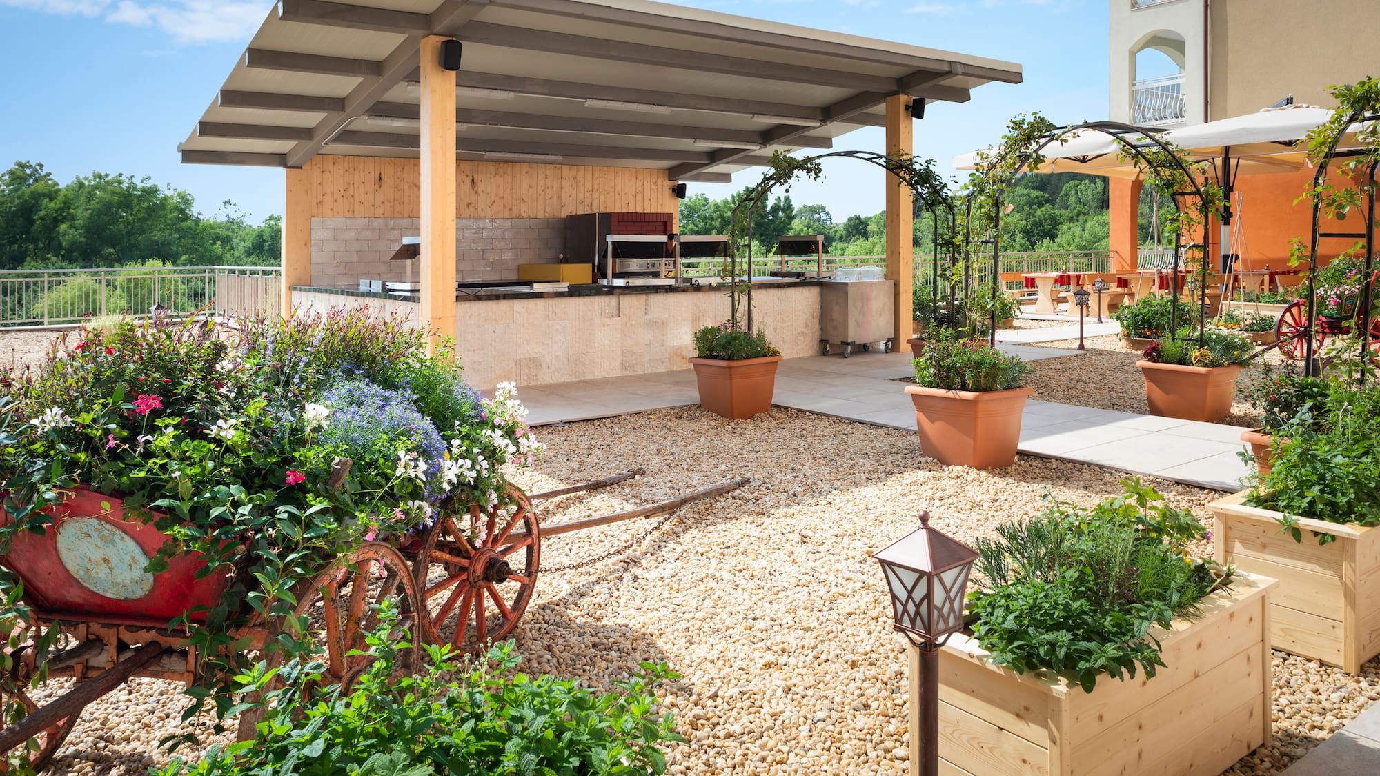 a patio with a covered area with plants and a roof