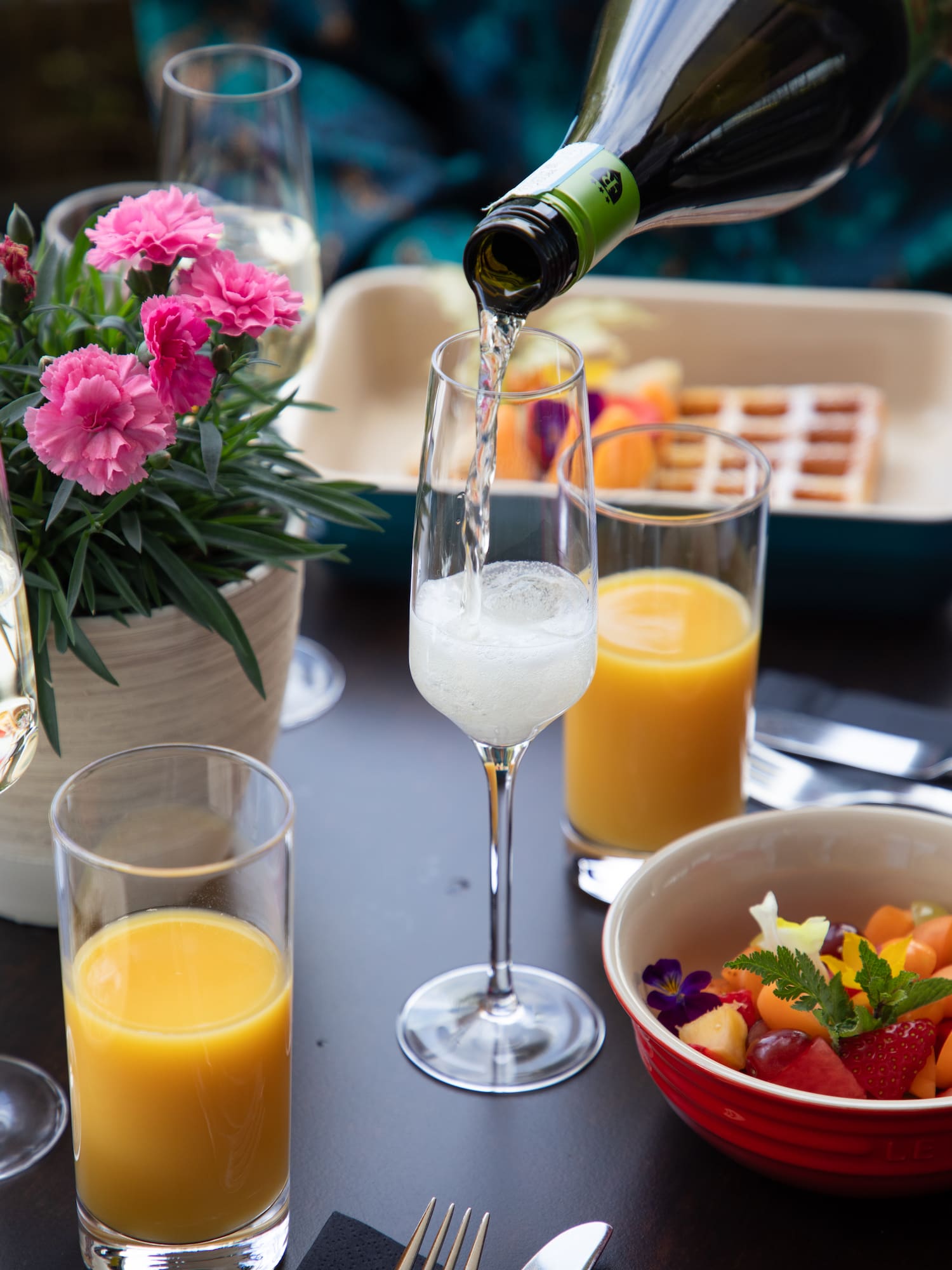 a glass of champagne being poured into a glass